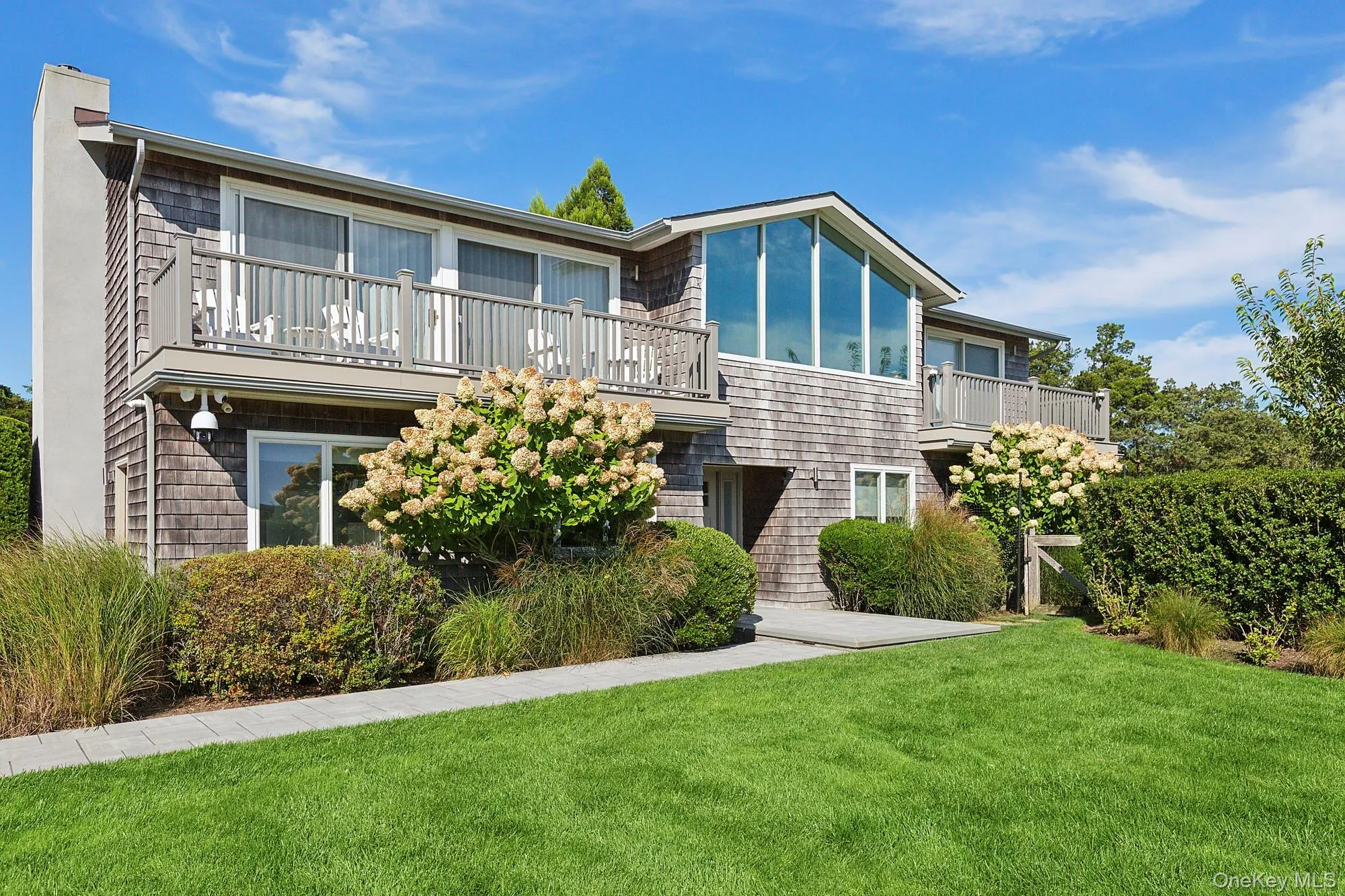 Back of house with a balcony and a lawn Back of house with a balcony and a lawn