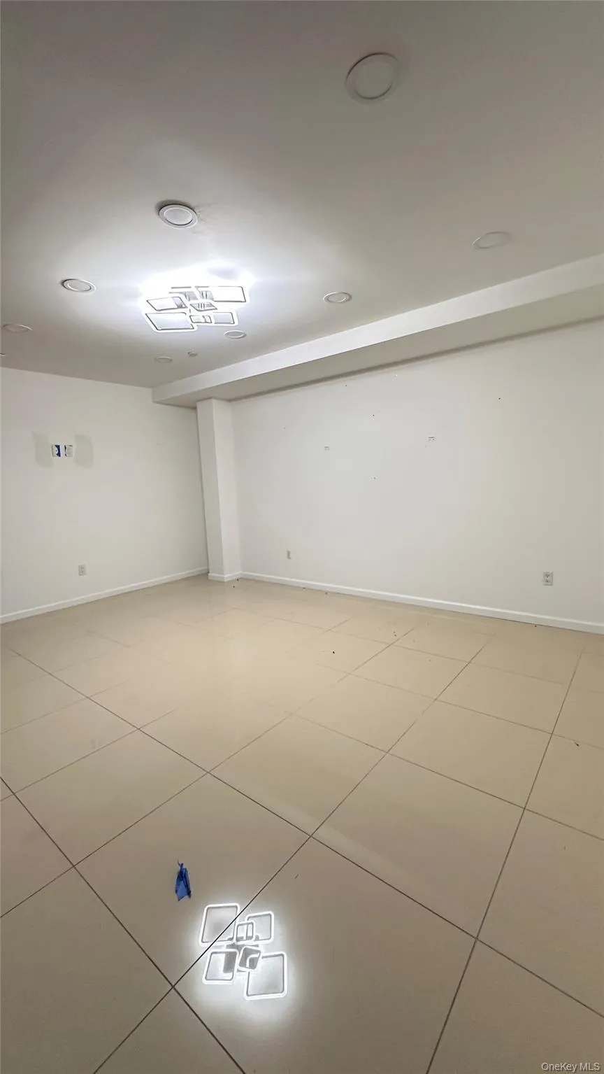 Spare room with baseboards and light tile patterned floors Spare room with baseboards and light tile patterned floors