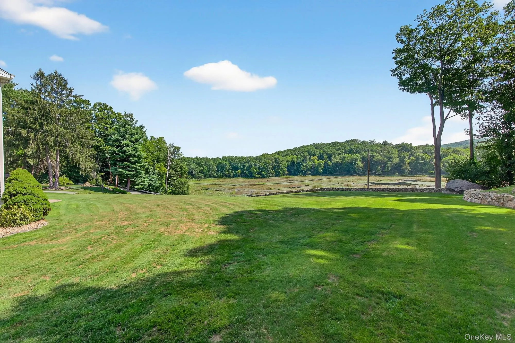 View of green lawn going down to Barrett Pond View of green lawn going down to Barrett Pond