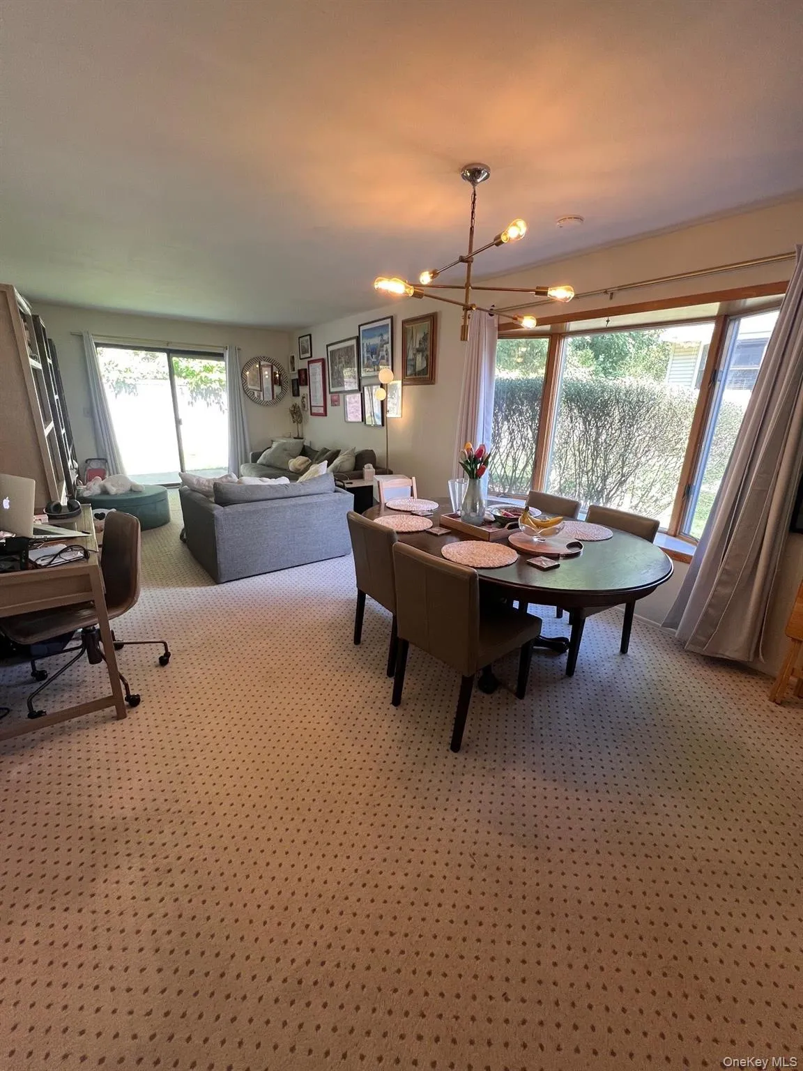 Dining room with plenty of natural light from bay window and sliders to patio. Dining room with plenty of natural light from bay window and sliders to patio.
