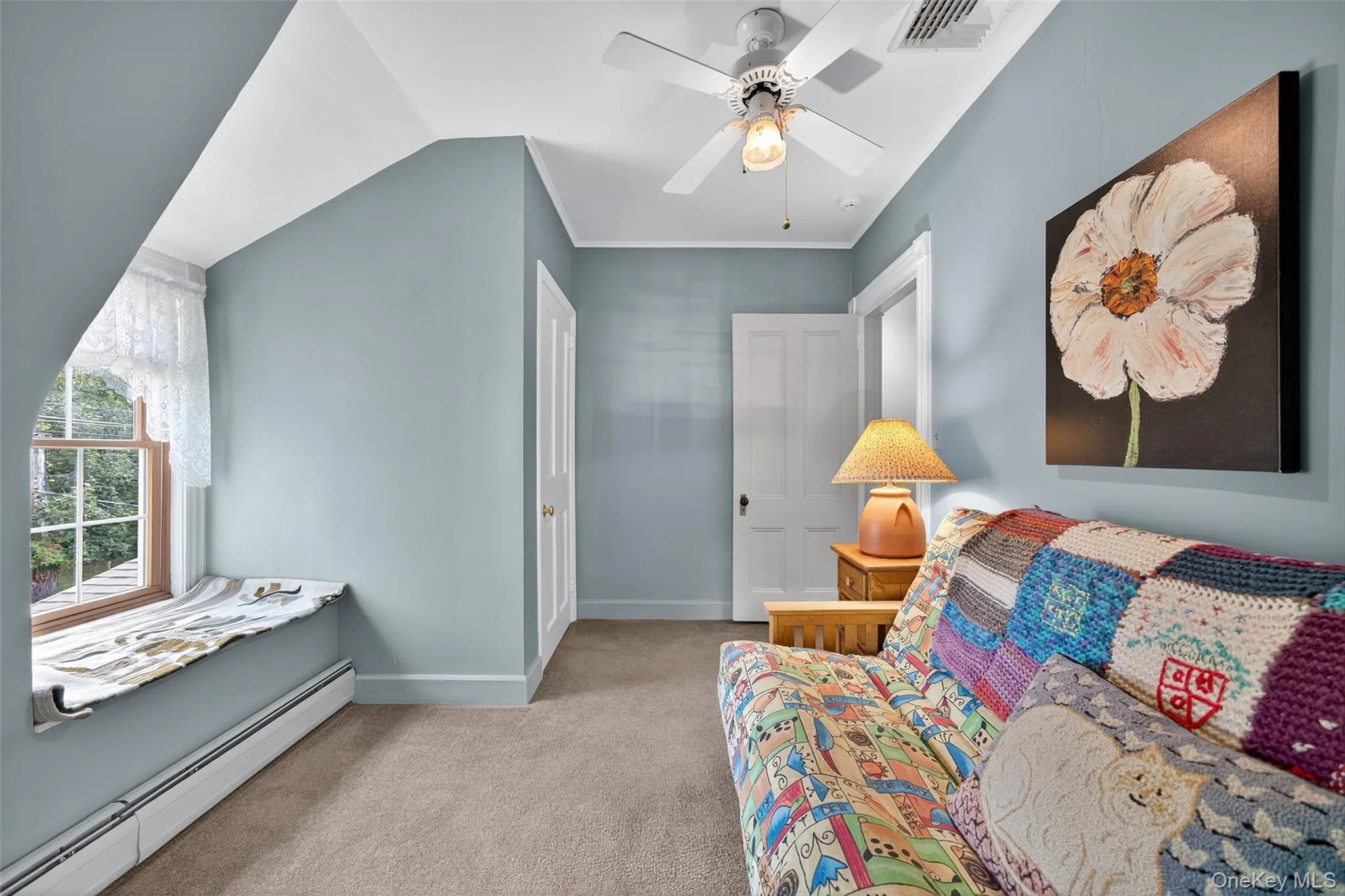 Bedroom #5 featuring a baseboard heating unit, light colored carpet, and crown molding Bedroom #5 featuring a baseboard heating unit, light colored carpet, and crown molding