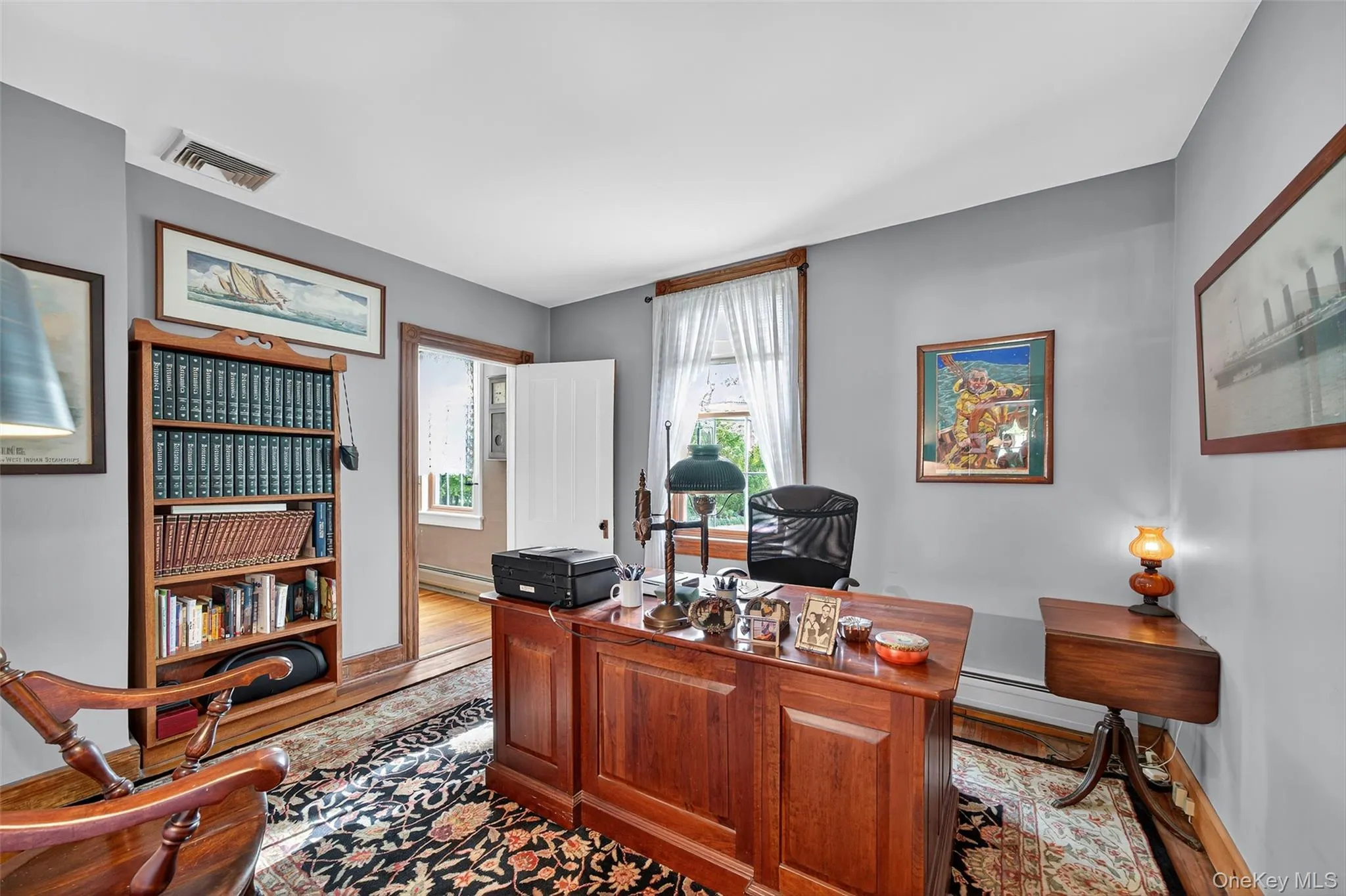 Office/Bedroom #2 featuring light wood-style floors and a baseboard radiator Office/Bedroom #2 featuring light wood-style floors and a baseboard radiator