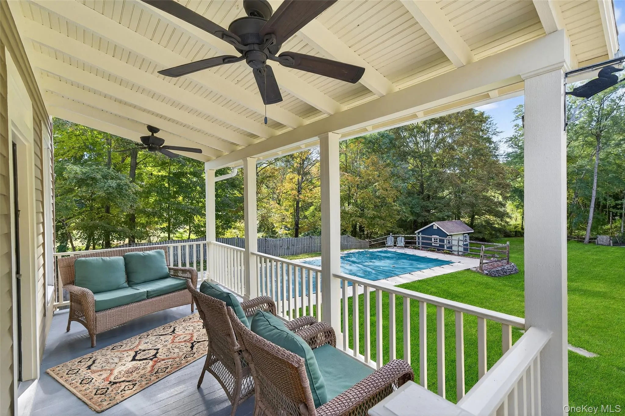 Deck with an outdoor living space, an outbuilding, view of wooded area, and a patio Deck with an outdoor living space, an outbuilding, view of wooded area, and a patio