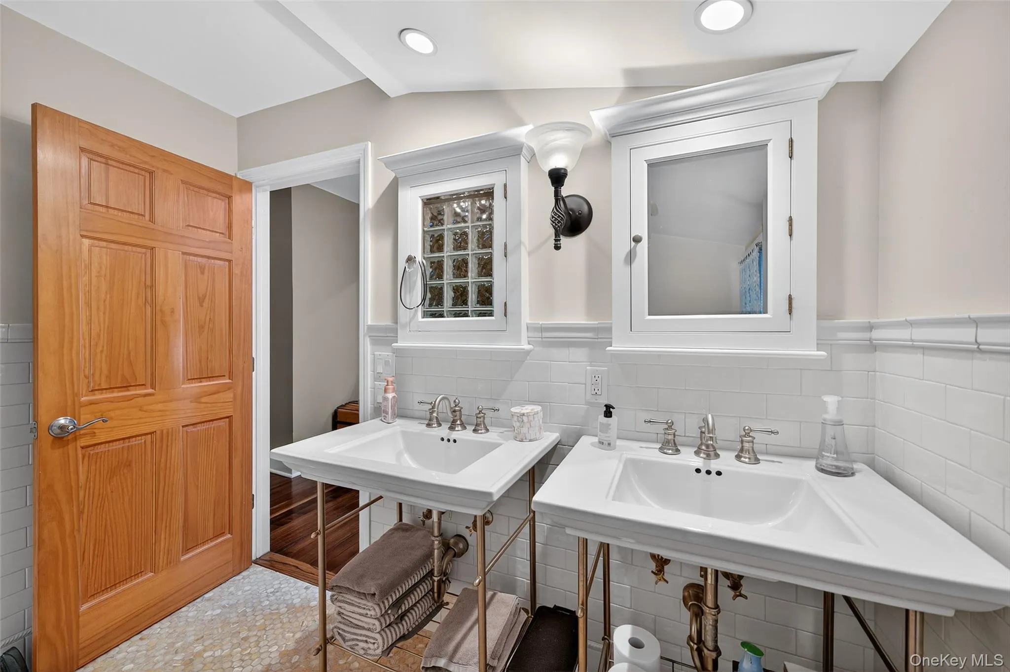 Bathroom featuring tile walls and a wainscoted wall Bathroom featuring tile walls and a wainscoted wall