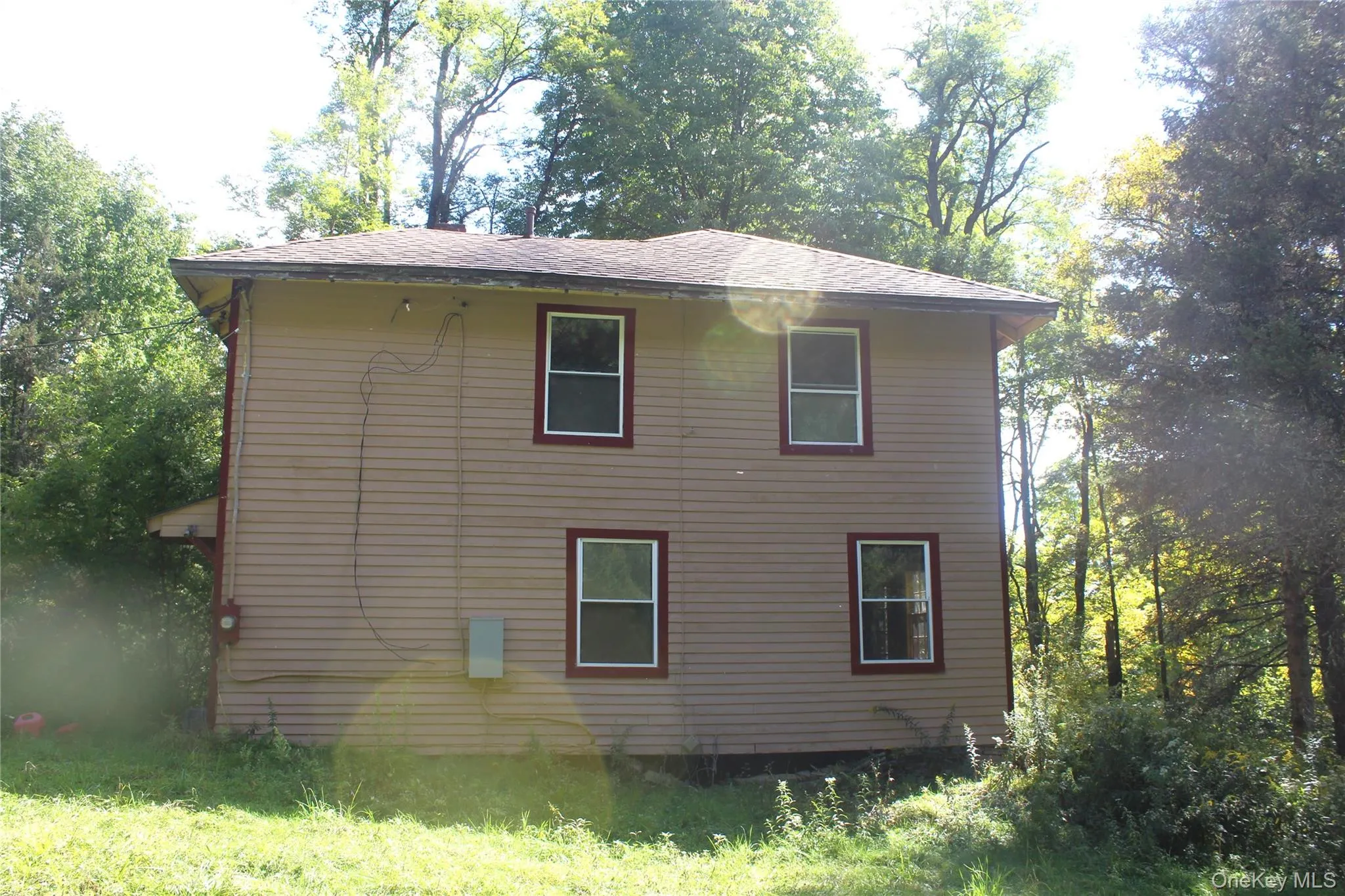 View of home's exterior featuring a shingled roof View of home's exterior featuring a shingled roof