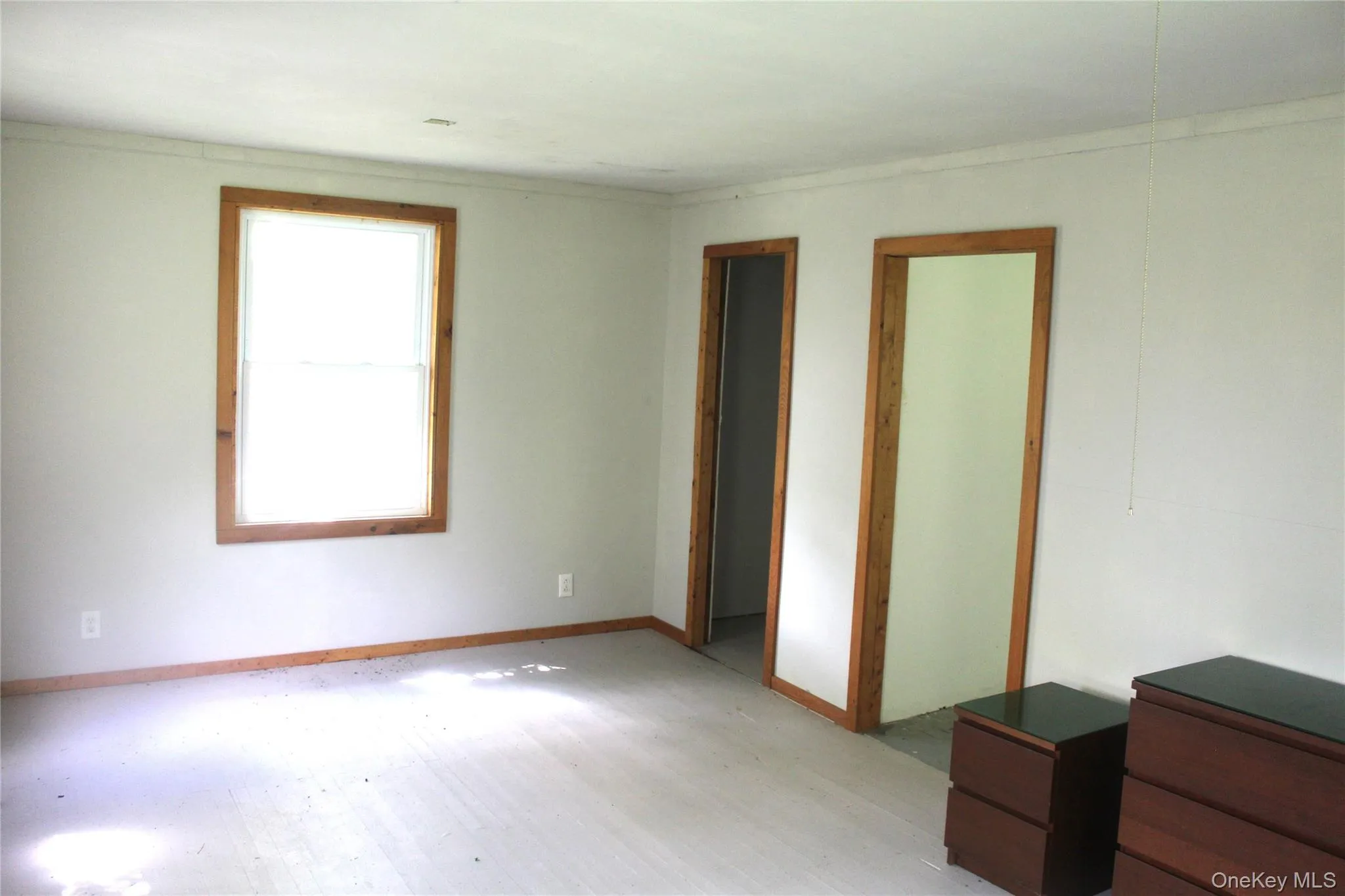 Spare room with wood finished floors and baseboards Spare room with wood finished floors and baseboards