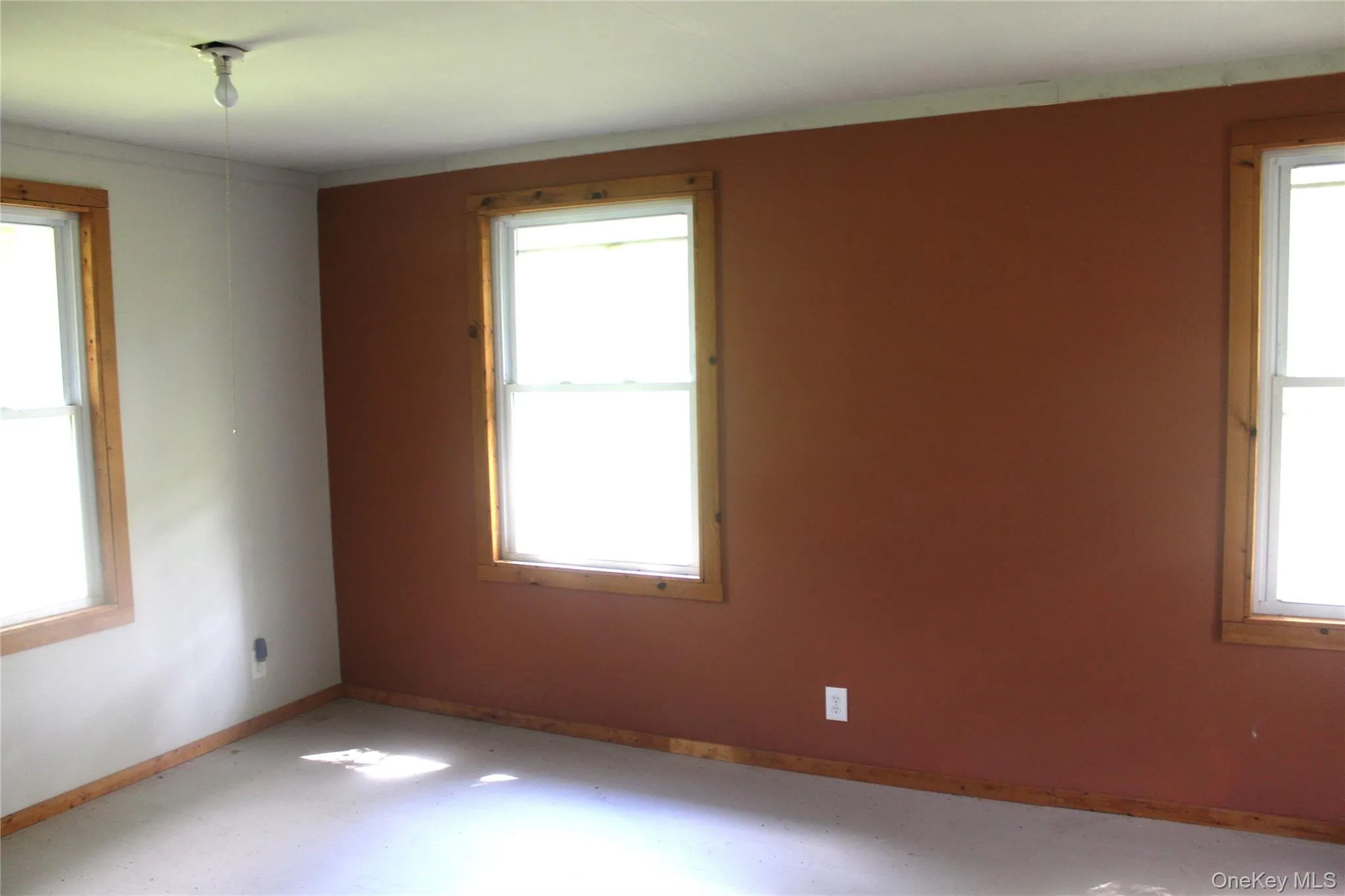 Unfurnished room with baseboards Unfurnished room with baseboards