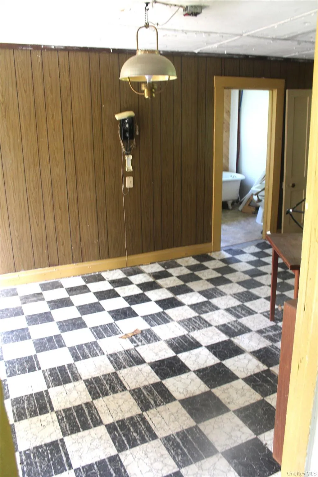 Unfurnished room featuring wooden walls Unfurnished room featuring wooden walls