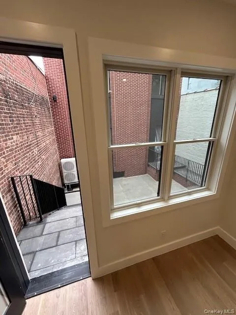 Doorway to outside with baseboards and wood finished floors Doorway to outside with baseboards and wood finished floors