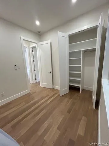 Unfurnished bedroom featuring light wood-style flooring, a closet, and recessed lighting Unfurnished bedroom featuring light wood-style flooring, a closet, and recessed lighting