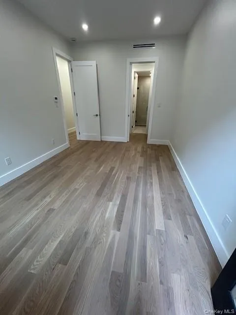 Unfurnished bedroom featuring light wood-style floors and recessed lighting Unfurnished bedroom featuring light wood-style floors and recessed lighting