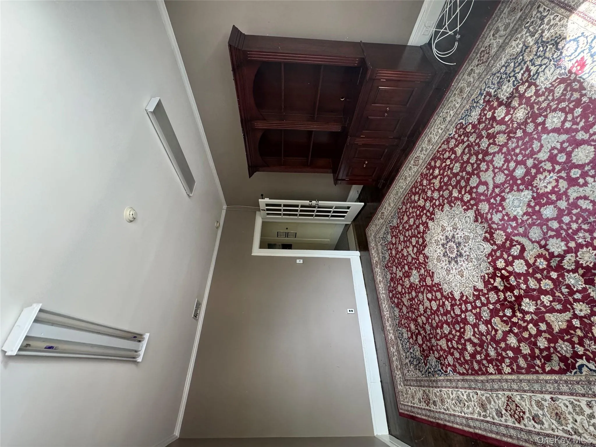 Living area with baseboards and crown molding Living area with baseboards and crown molding