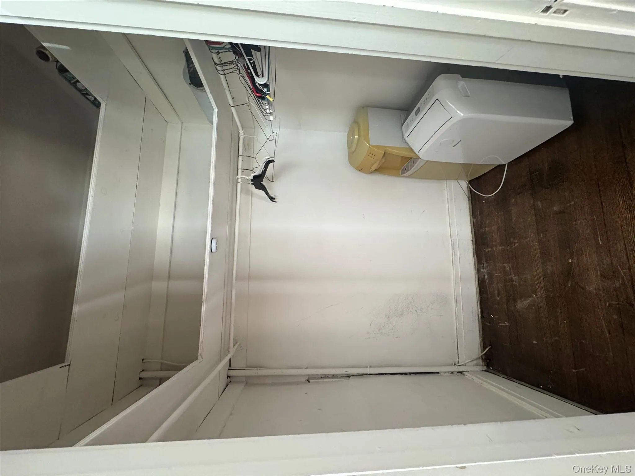 Spacious closet featuring dark wood-style floors Spacious closet featuring dark wood-style floors