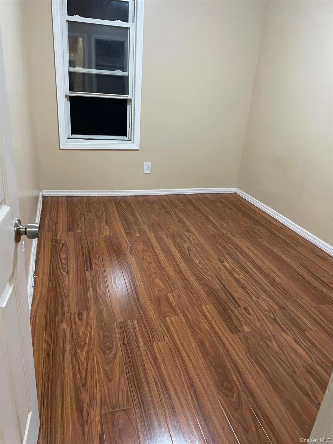 Spare room featuring dark wood finished floors and baseboards Spare room featuring dark wood finished floors and baseboards