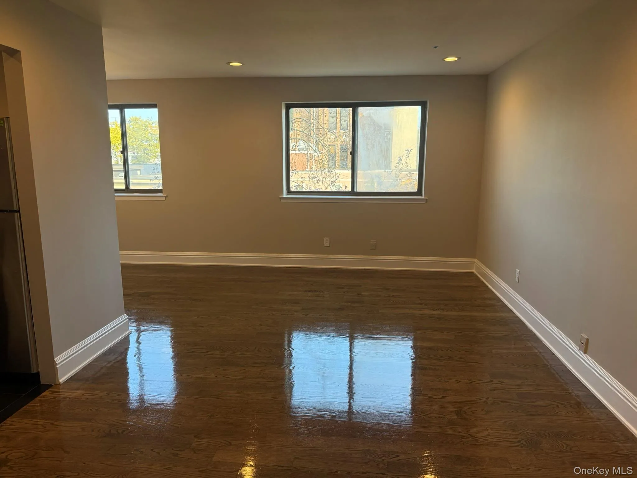 Spare room with dark wood-type flooring and recessed lighting Spare room with dark wood-type flooring and recessed lighting