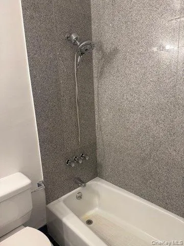 Full bathroom featuring bathtub / shower combination and toilet Full bathroom featuring bathtub / shower combination and toilet