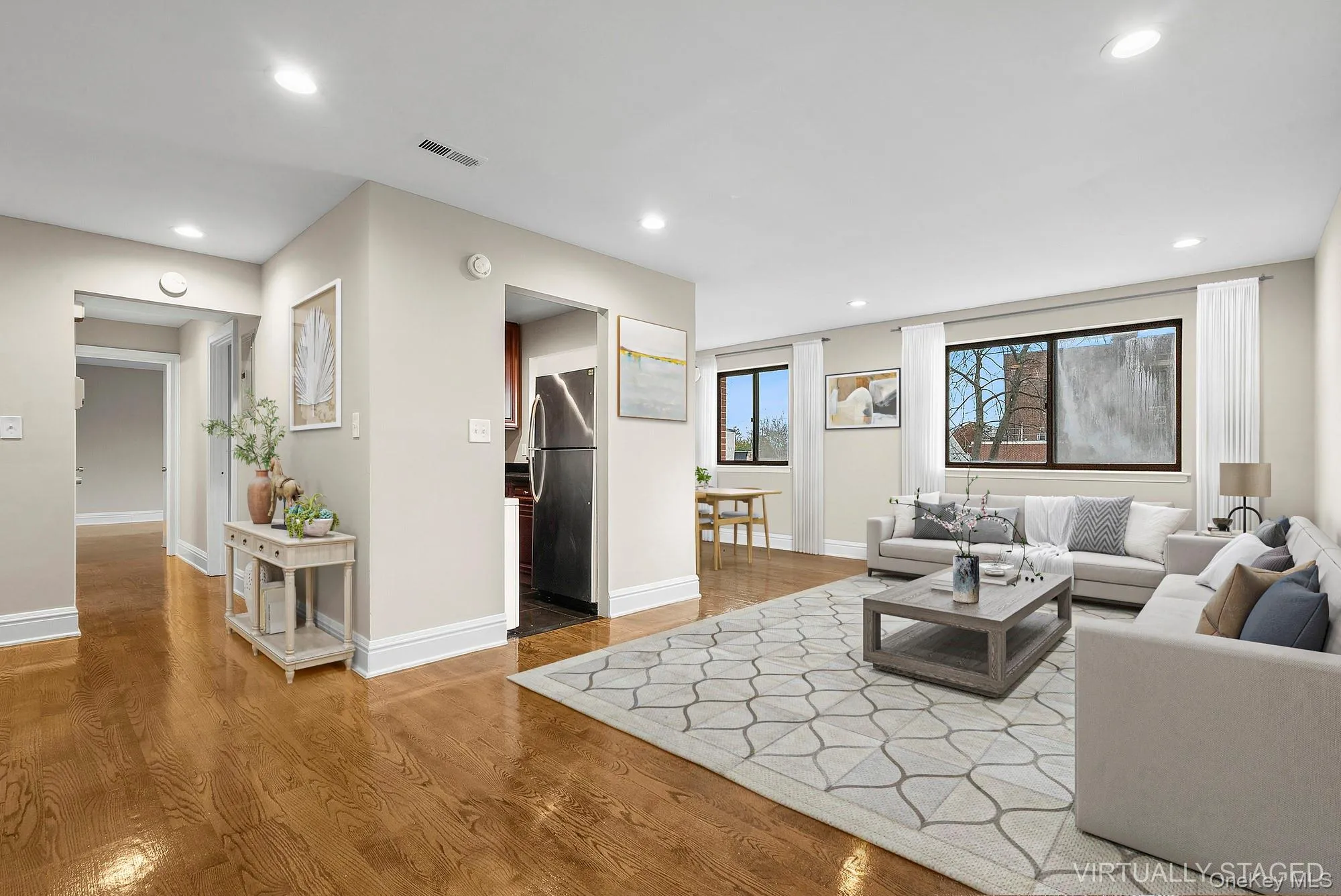 Living area with light wood-type flooring and recessed lighting Living area with light wood-type flooring and recessed lighting
