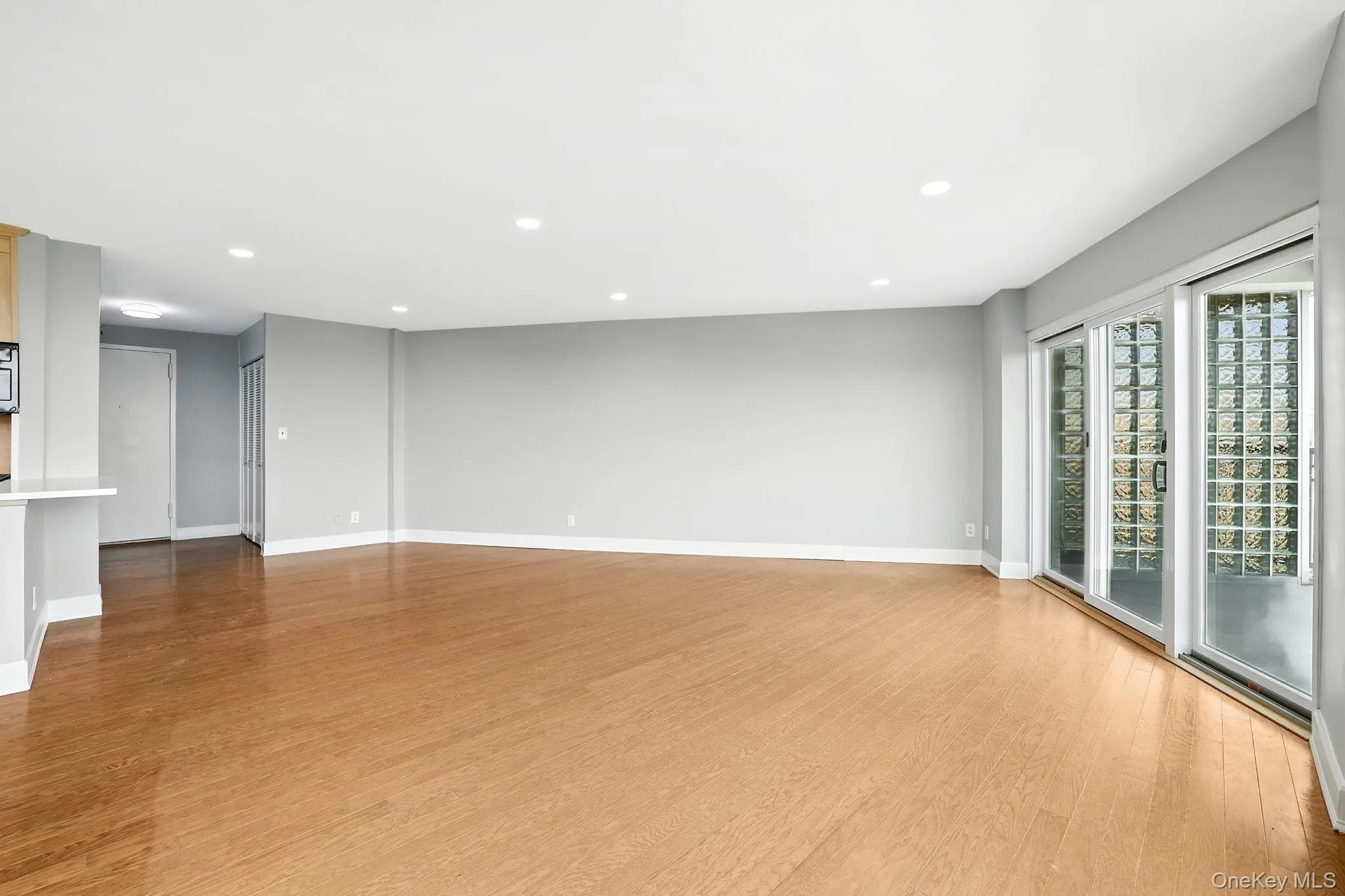 Unfurnished living room with recessed lighting and light wood floors Unfurnished living room with recessed lighting and light wood floors