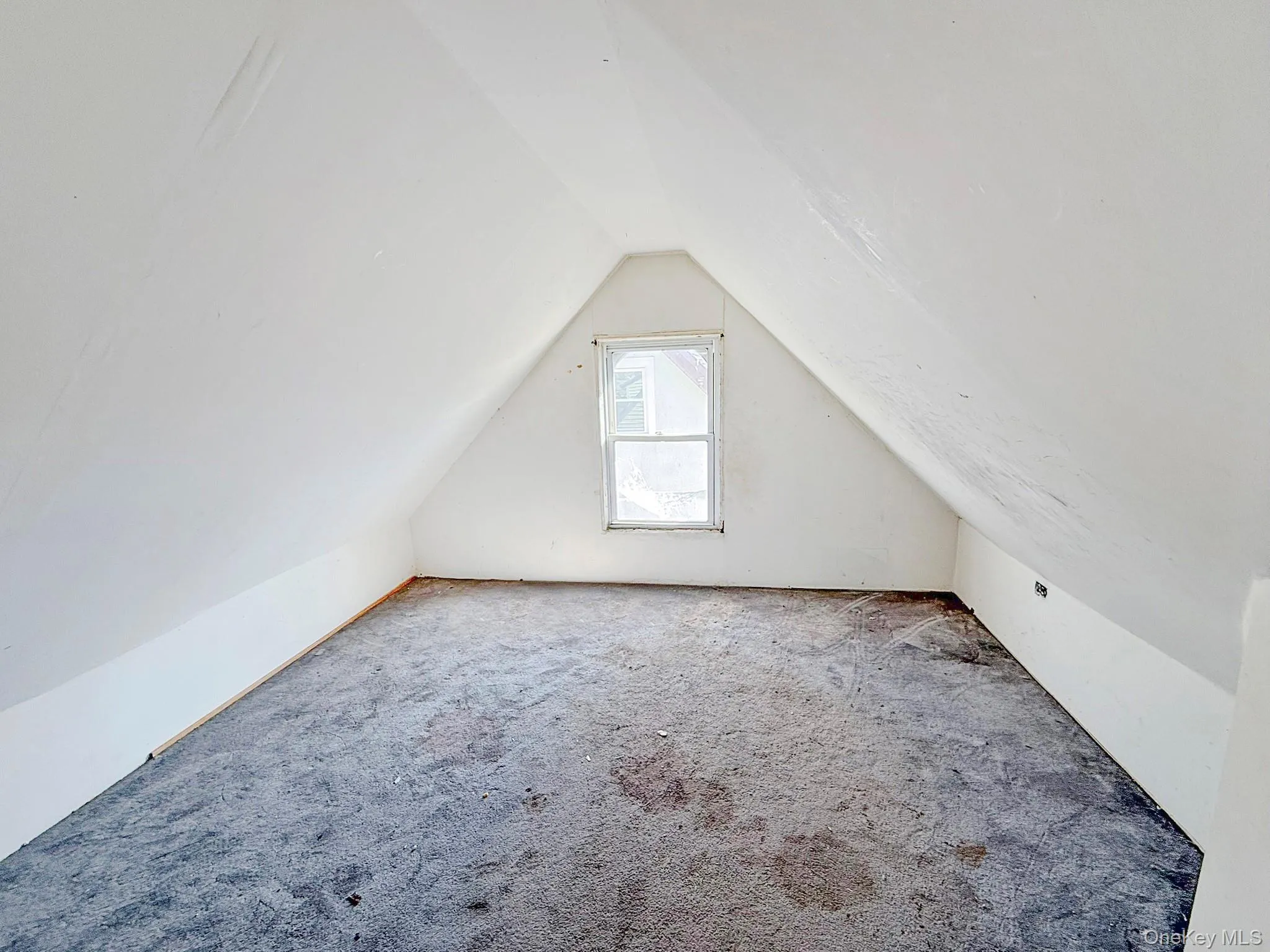 Bonus room featuring lofted ceiling and carpet Bonus room featuring lofted ceiling and carpet