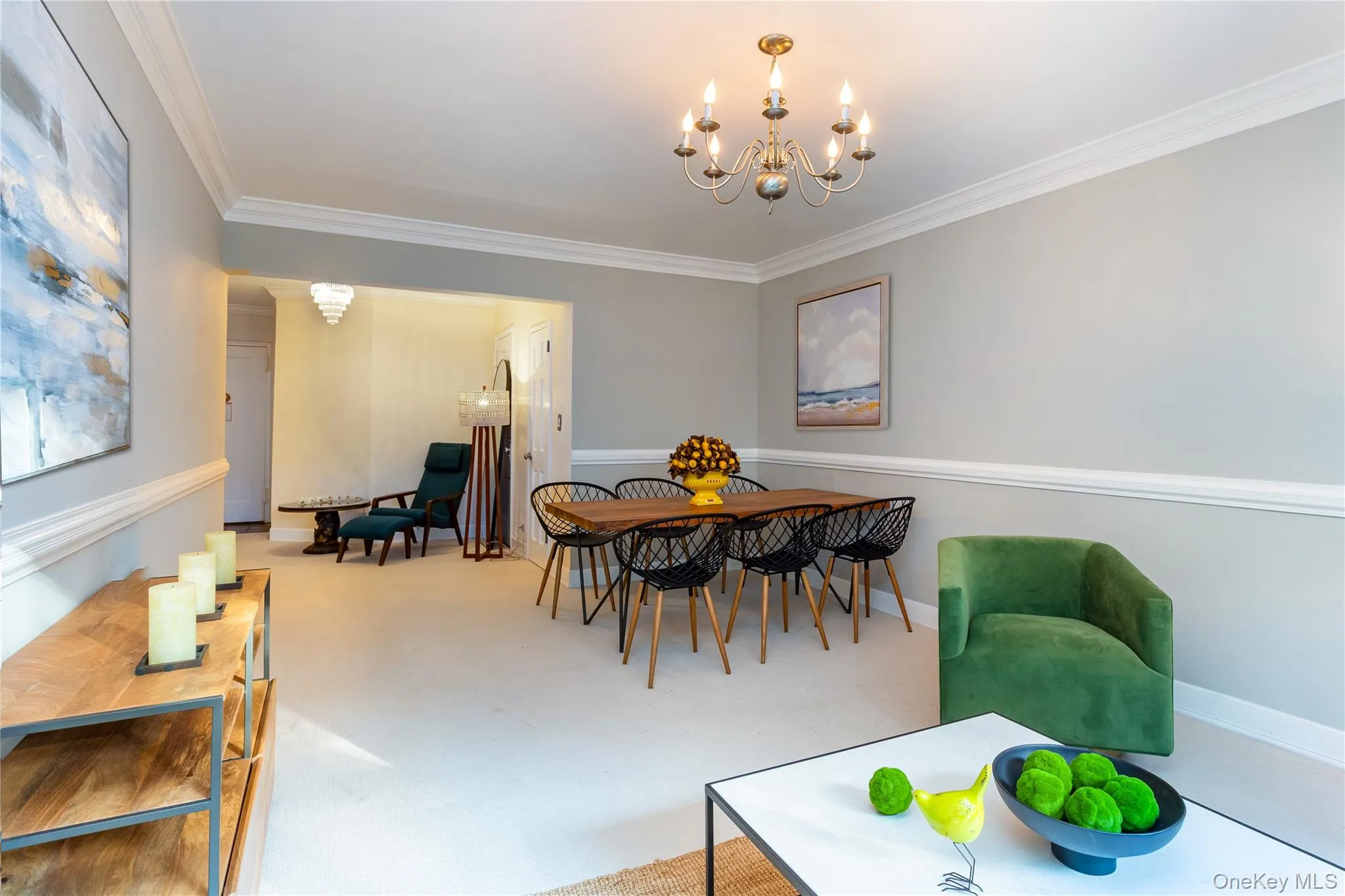 Dining space featuring a chandelier, ornamental molding, and concrete flooring Dining space featuring a chandelier, ornamental molding, and concrete flooring