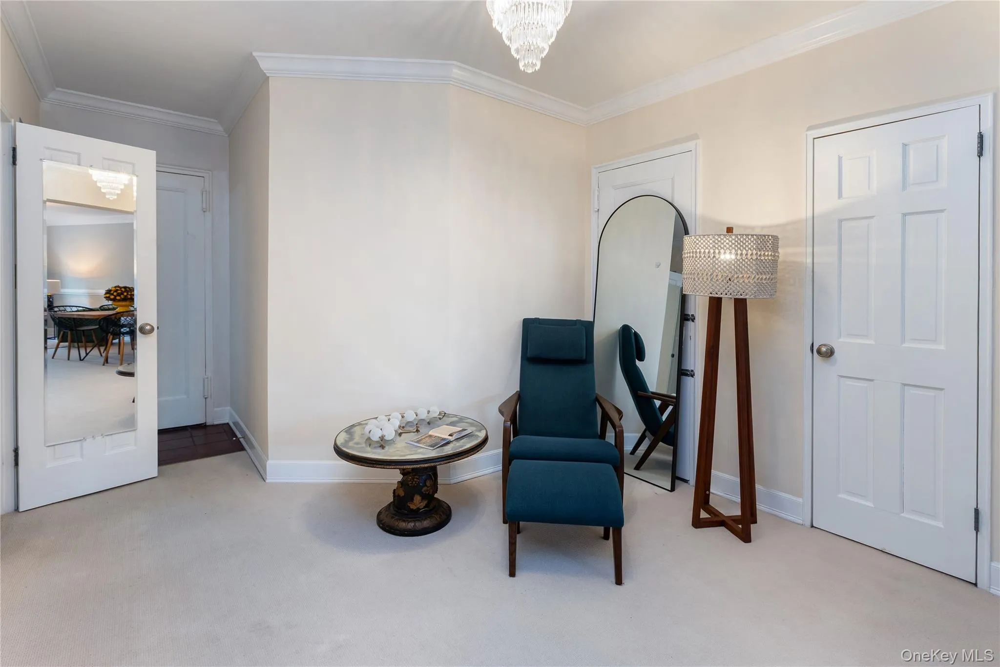 Sitting room with crown molding, light colored carpet, and a chandelier Sitting room with crown molding, light colored carpet, and a chandelier