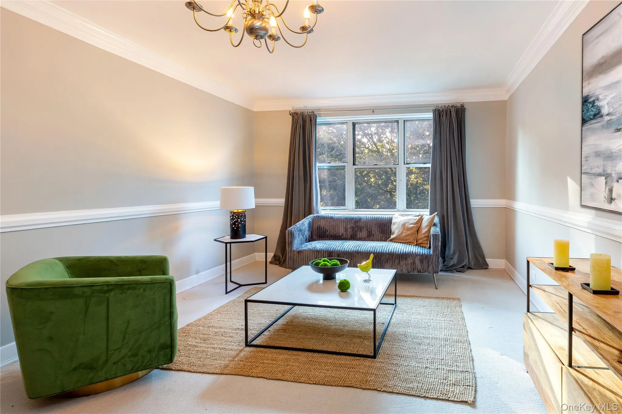 Sitting room with ornamental molding, a chandelier, and carpet Sitting room with ornamental molding, a chandelier, and carpet