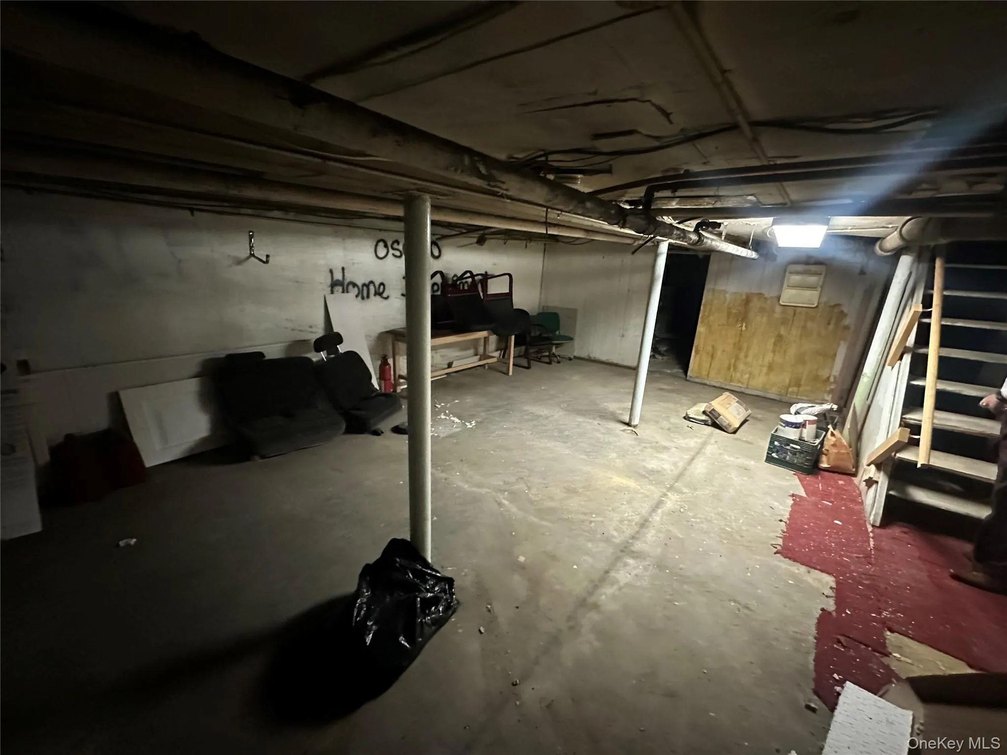 Unfinished basement featuring stairs Unfinished basement featuring stairs