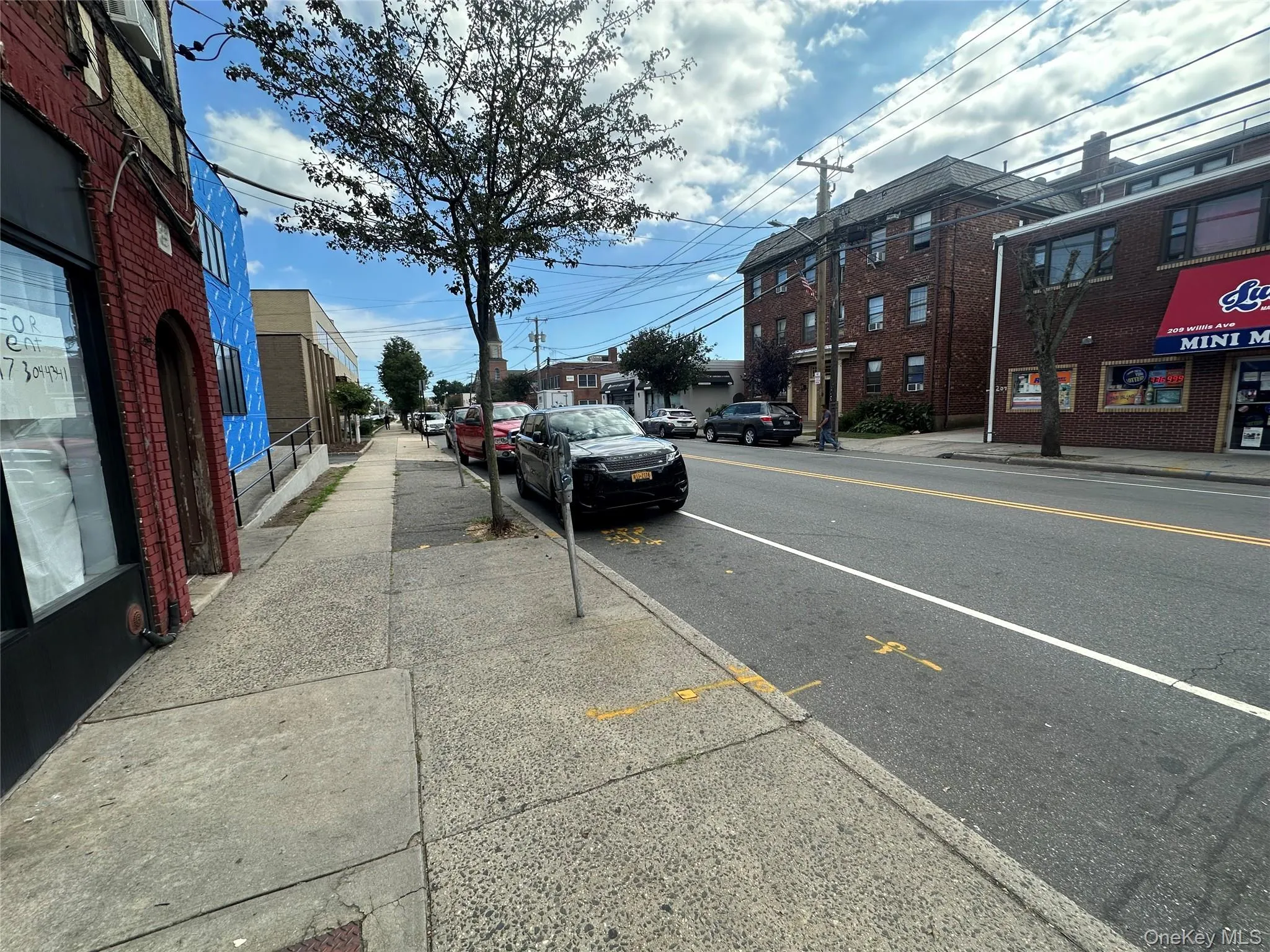 View of asphalt road featuring sidewalks and curbs View of asphalt road featuring sidewalks and curbs