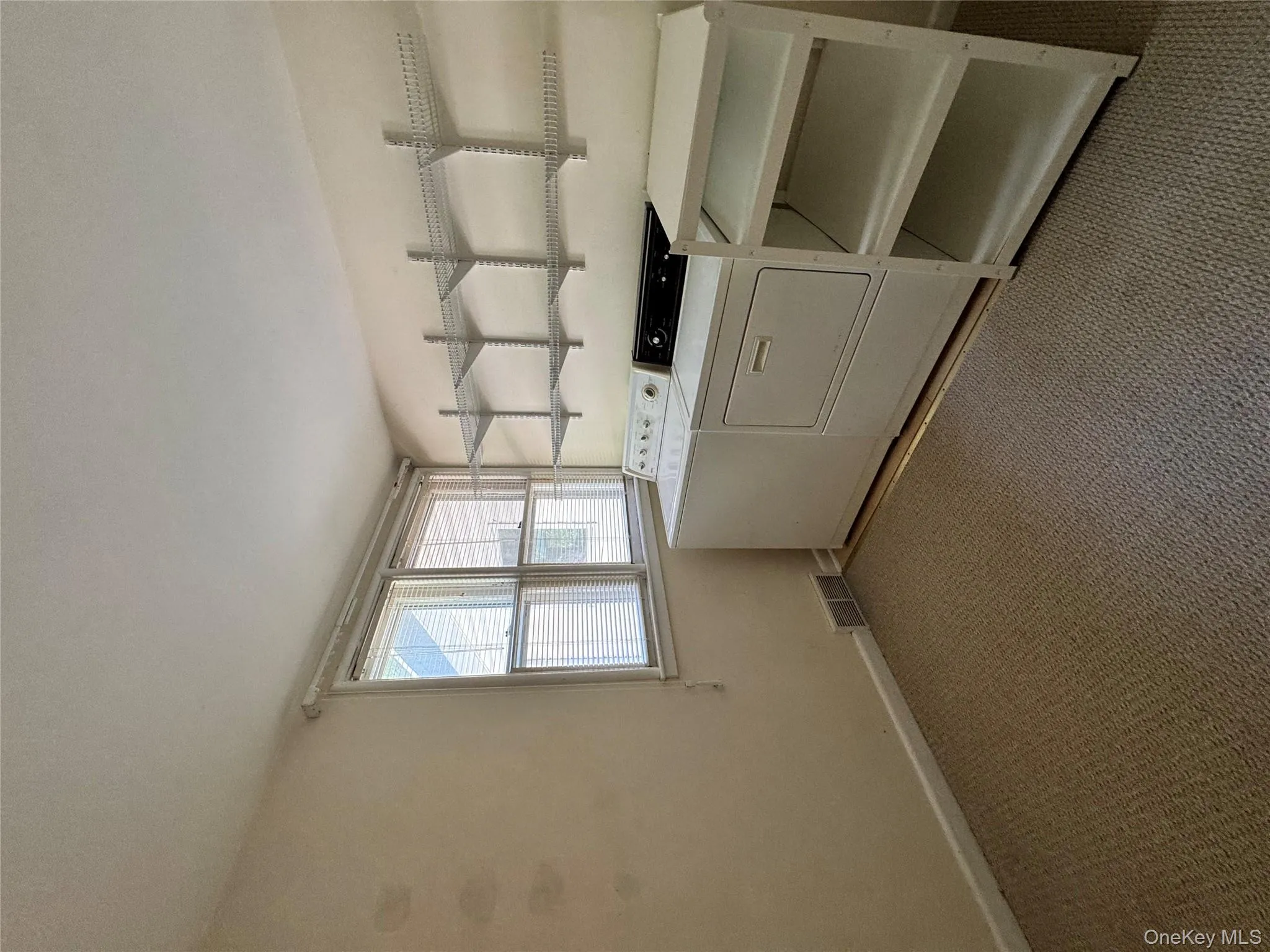 Laundry area with carpet floors and washing machine and clothes dryer Laundry area with carpet floors and washing machine and clothes dryer