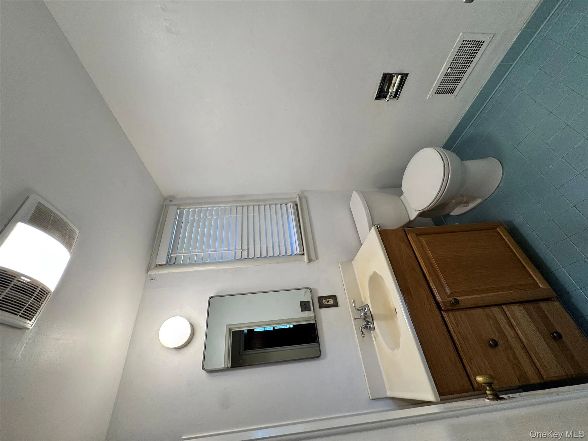 Bathroom with vanity and dark tile patterned flooring Bathroom with vanity and dark tile patterned flooring