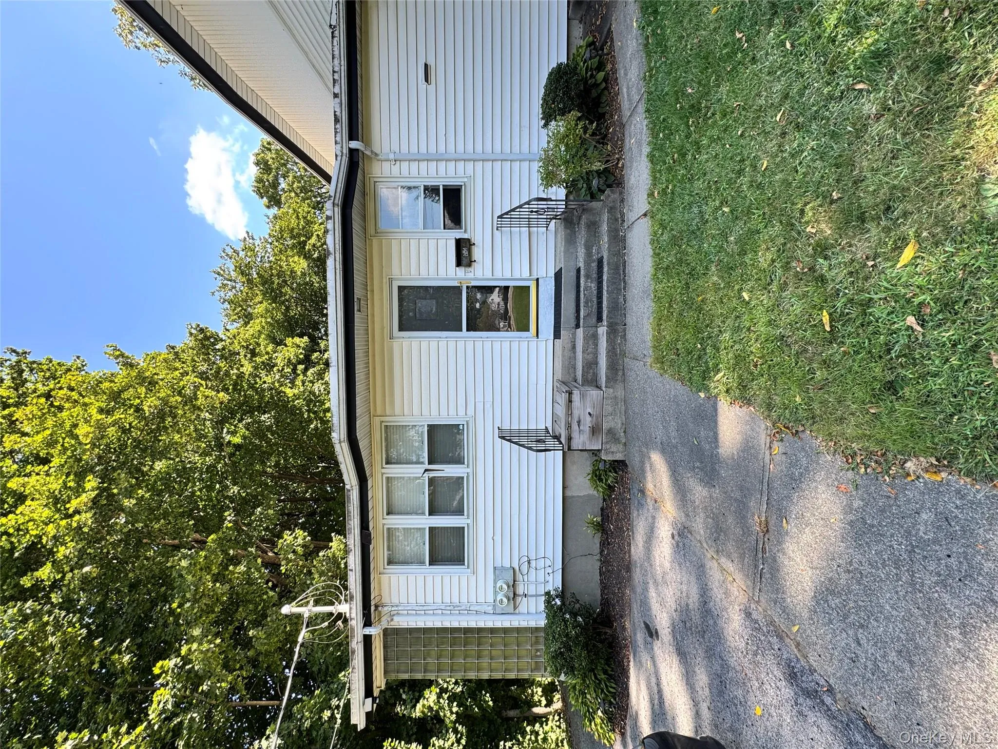 View of exterior entry with a yard View of exterior entry with a yard