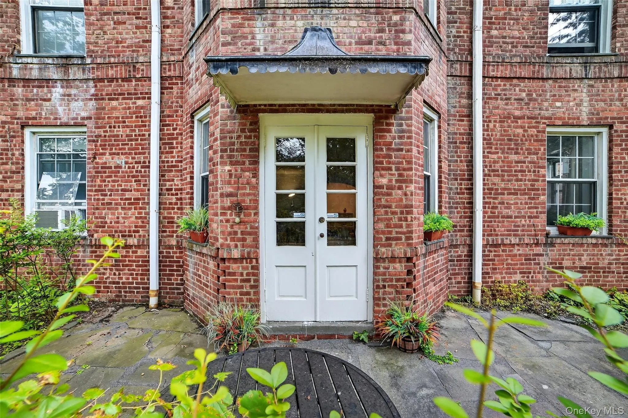 Entrance to property with brick siding and french doors Entrance to property with brick siding and french doors
