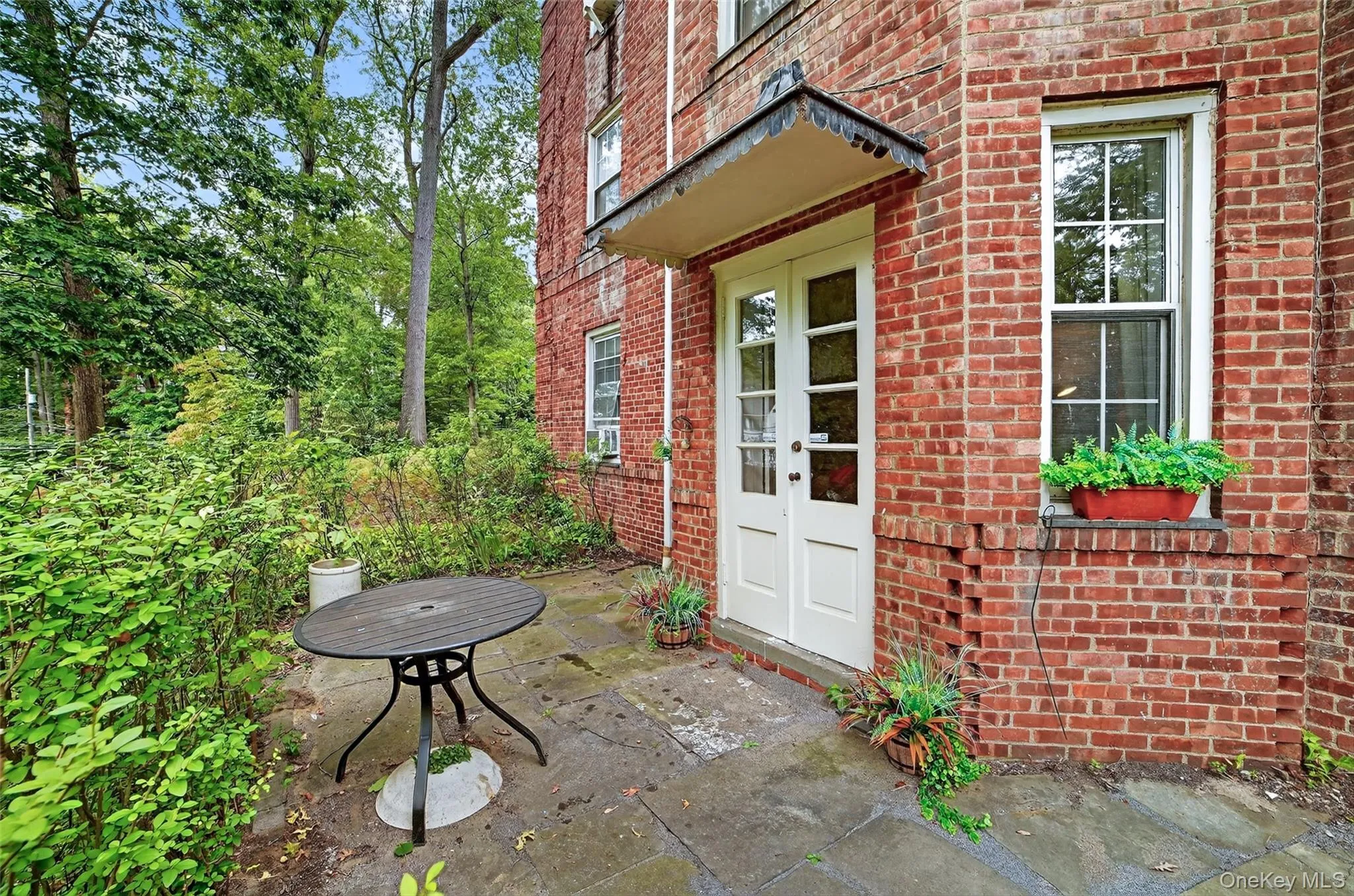 Doorway to property featuring brick siding Doorway to property featuring brick siding