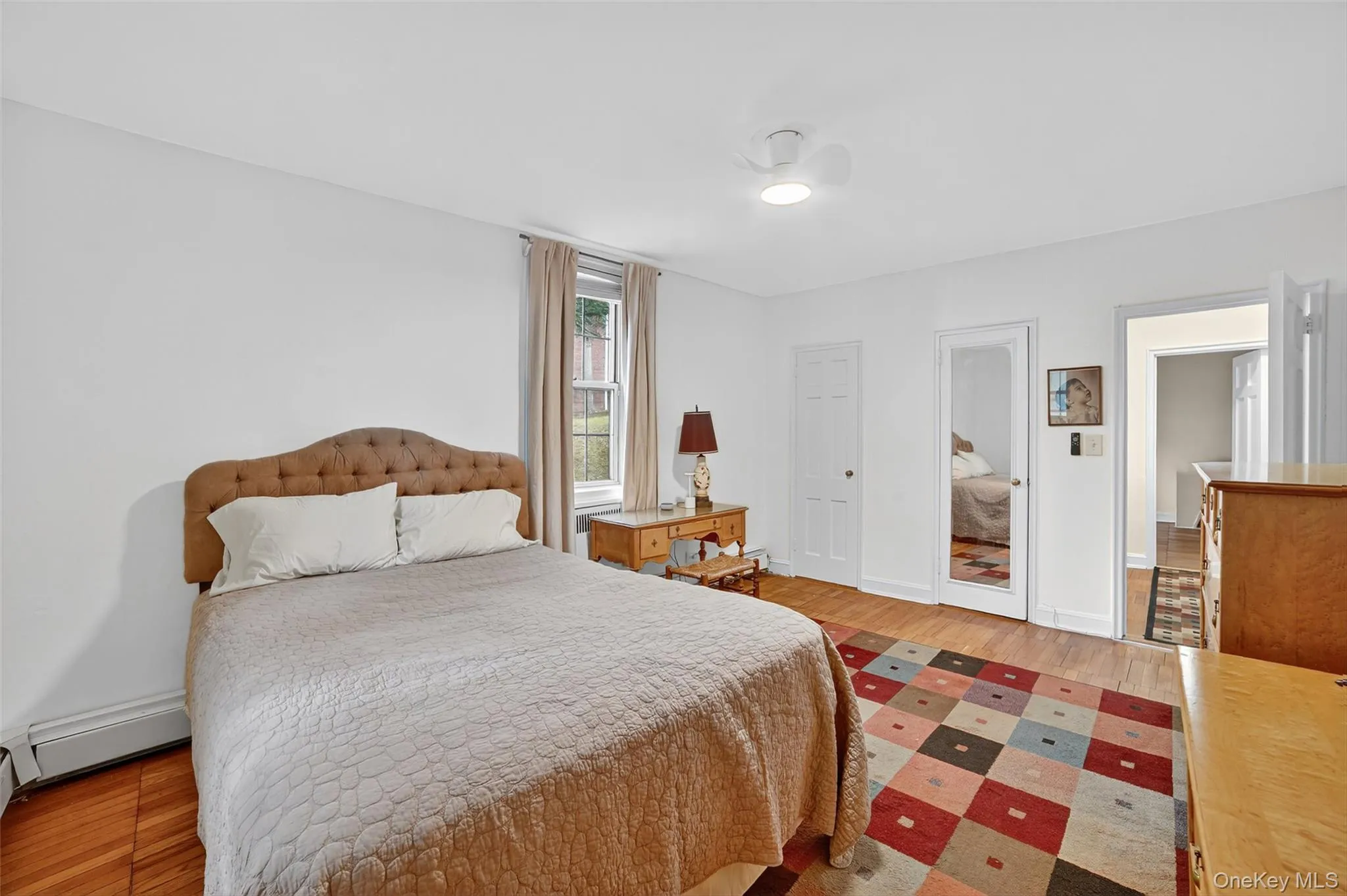Bedroom featuring light wood-style flooring and baseboards Bedroom featuring light wood-style flooring and baseboards