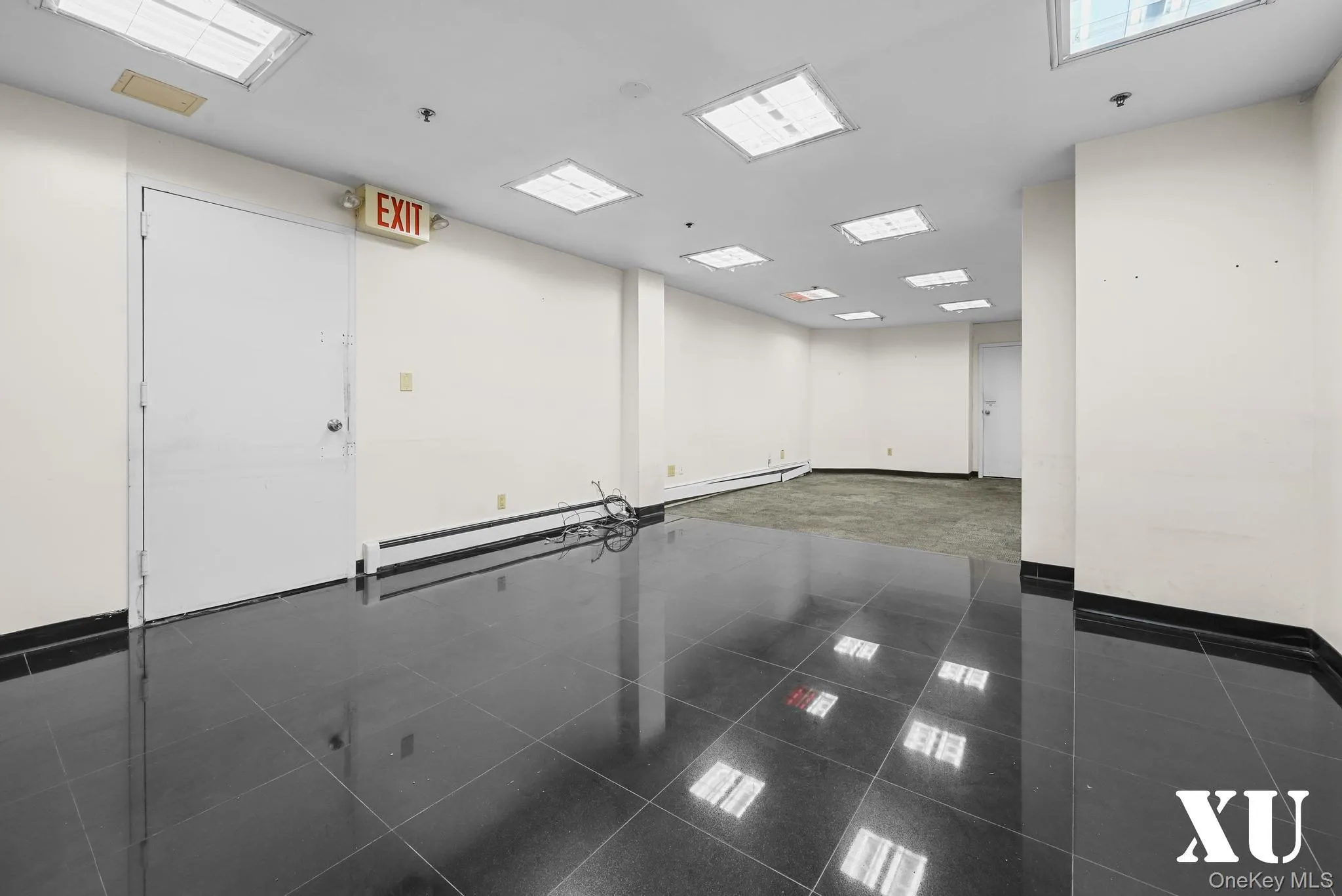 Unfurnished room featuring a baseboard radiator and granite floors Unfurnished room featuring a baseboard radiator and granite floors