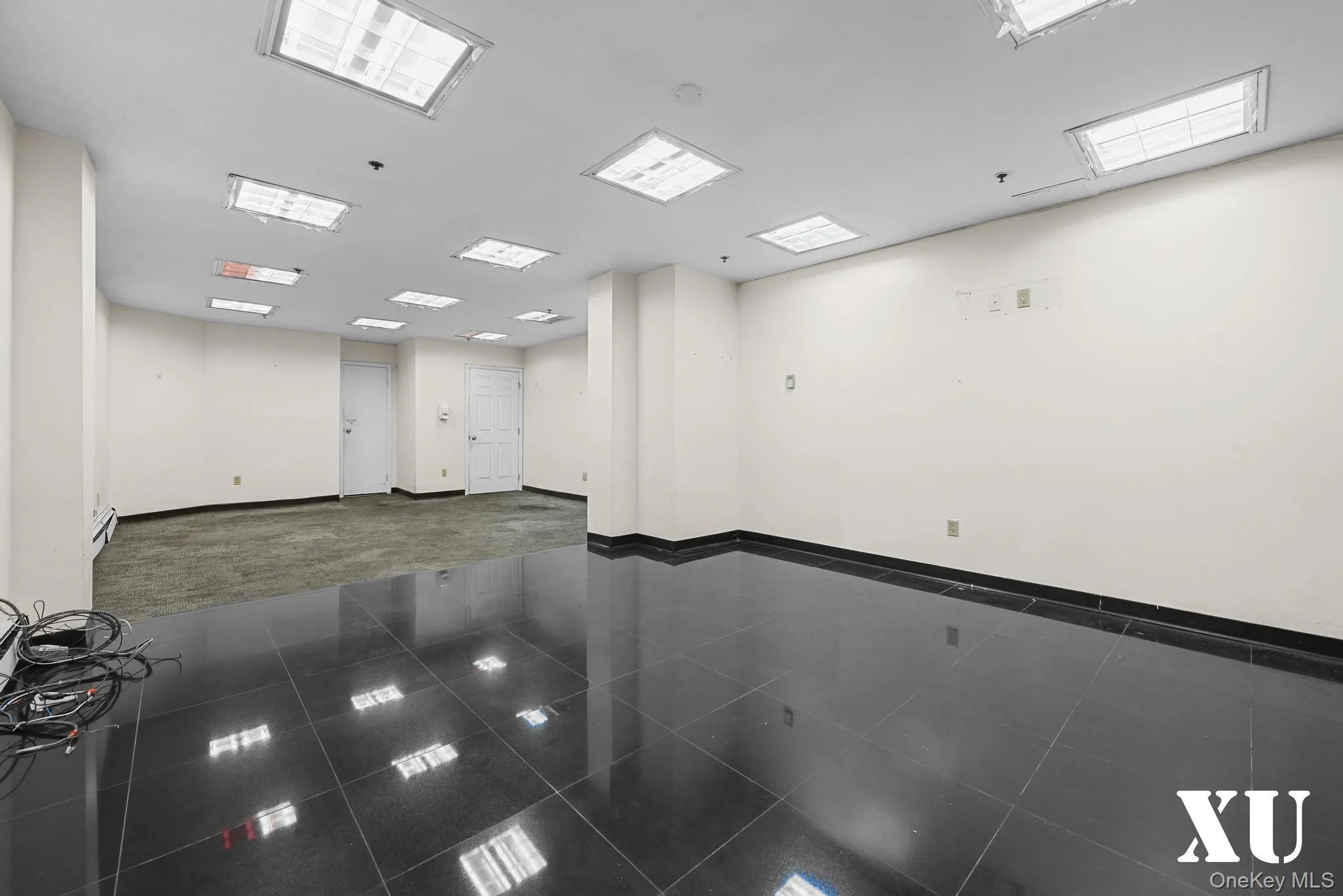 Spare room featuring granite tiled floors and a baseboard heating unit Spare room featuring granite tiled floors and a baseboard heating unit