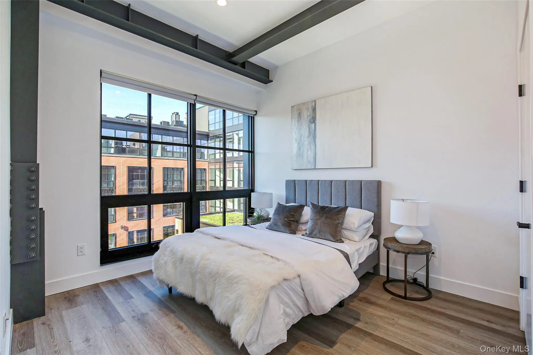 Bedroom featuring wood-type flooring and beam ceiling Bedroom featuring wood-type flooring and beam ceiling