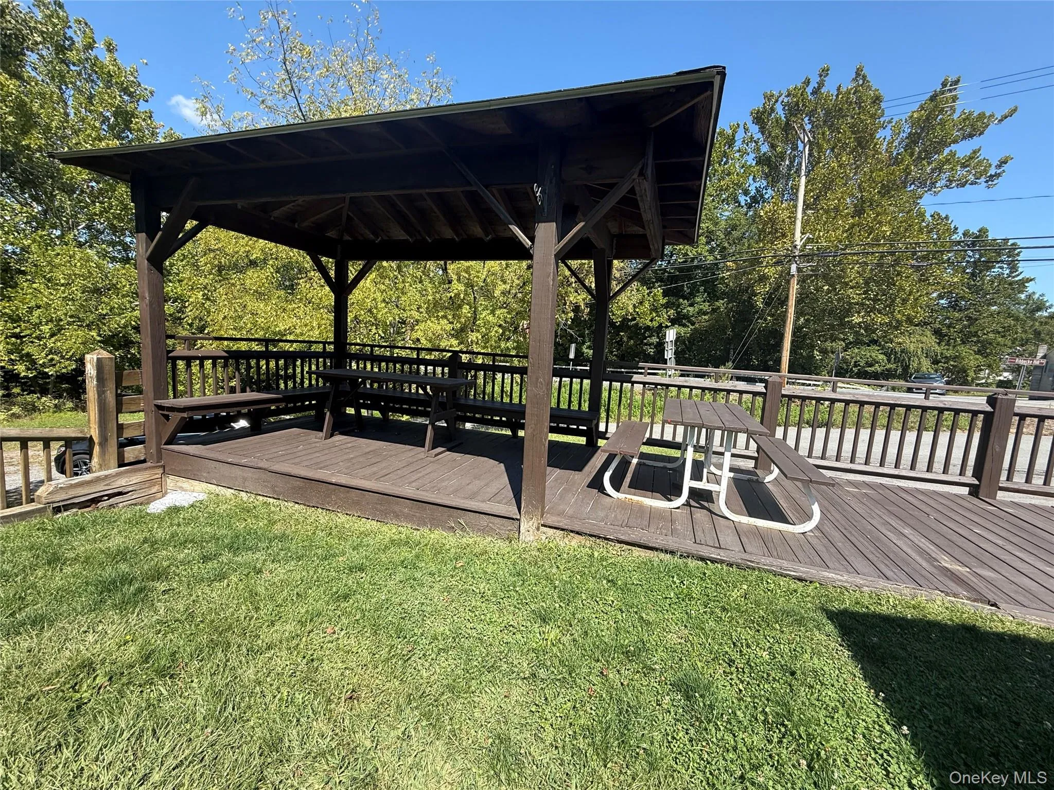 Deck with a lawn, view of wooded area, and a gazebo Deck with a lawn, view of wooded area, and a gazebo