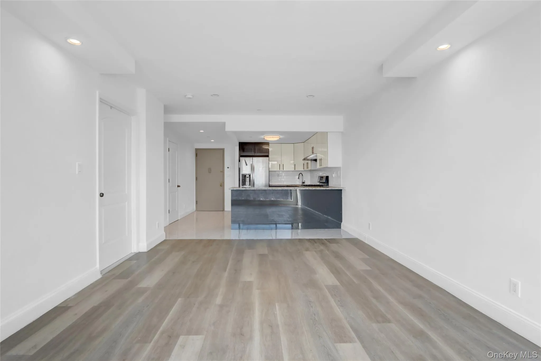 Unfurnished living room with recessed lighting and light wood-type flooring Unfurnished living room with recessed lighting and light wood-type flooring