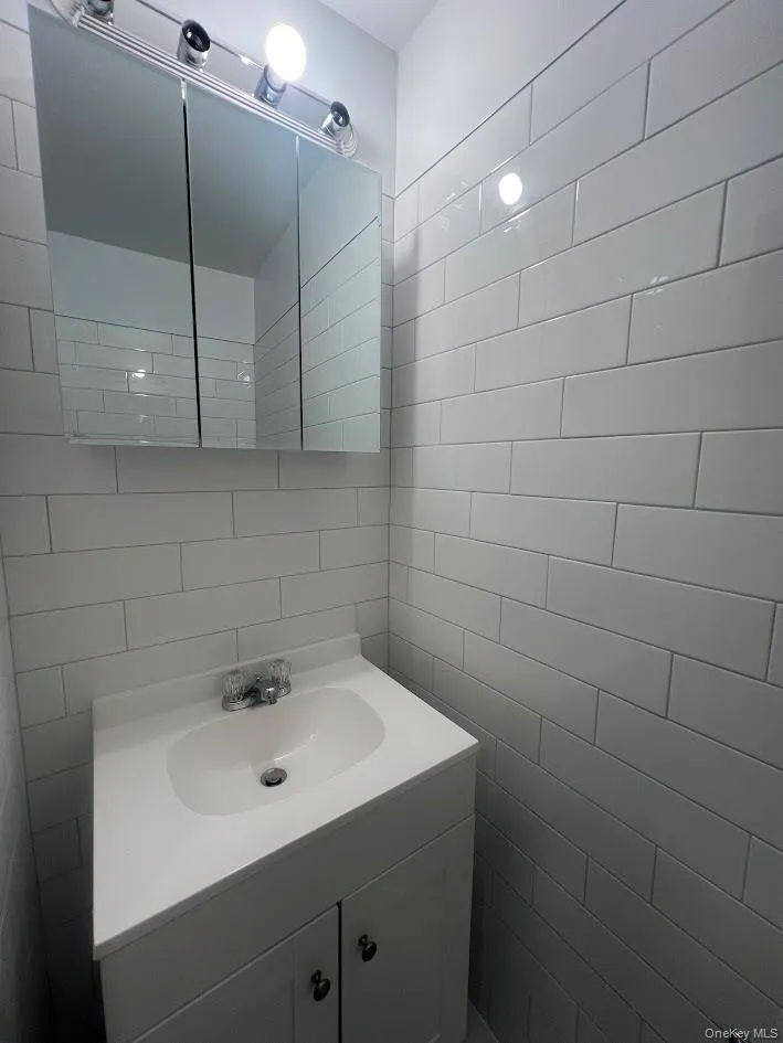 Bathroom with vanity and tile walls Bathroom with vanity and tile walls