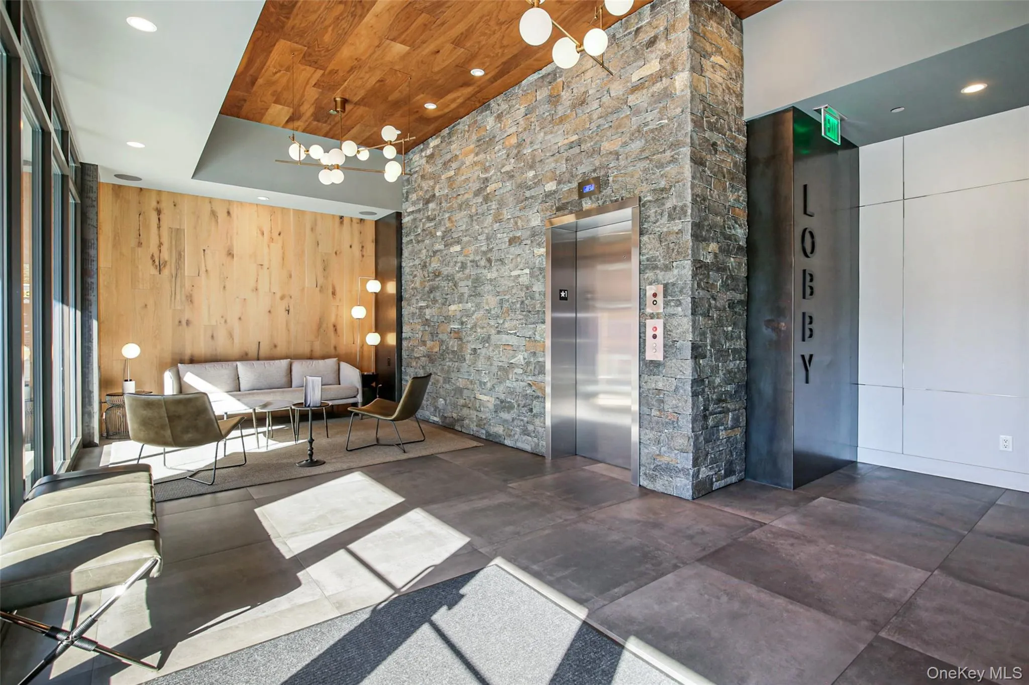 Building lobby featuring recessed lighting, wooden walls, and wooden ceiling Building lobby featuring recessed lighting, wooden walls, and wooden ceiling