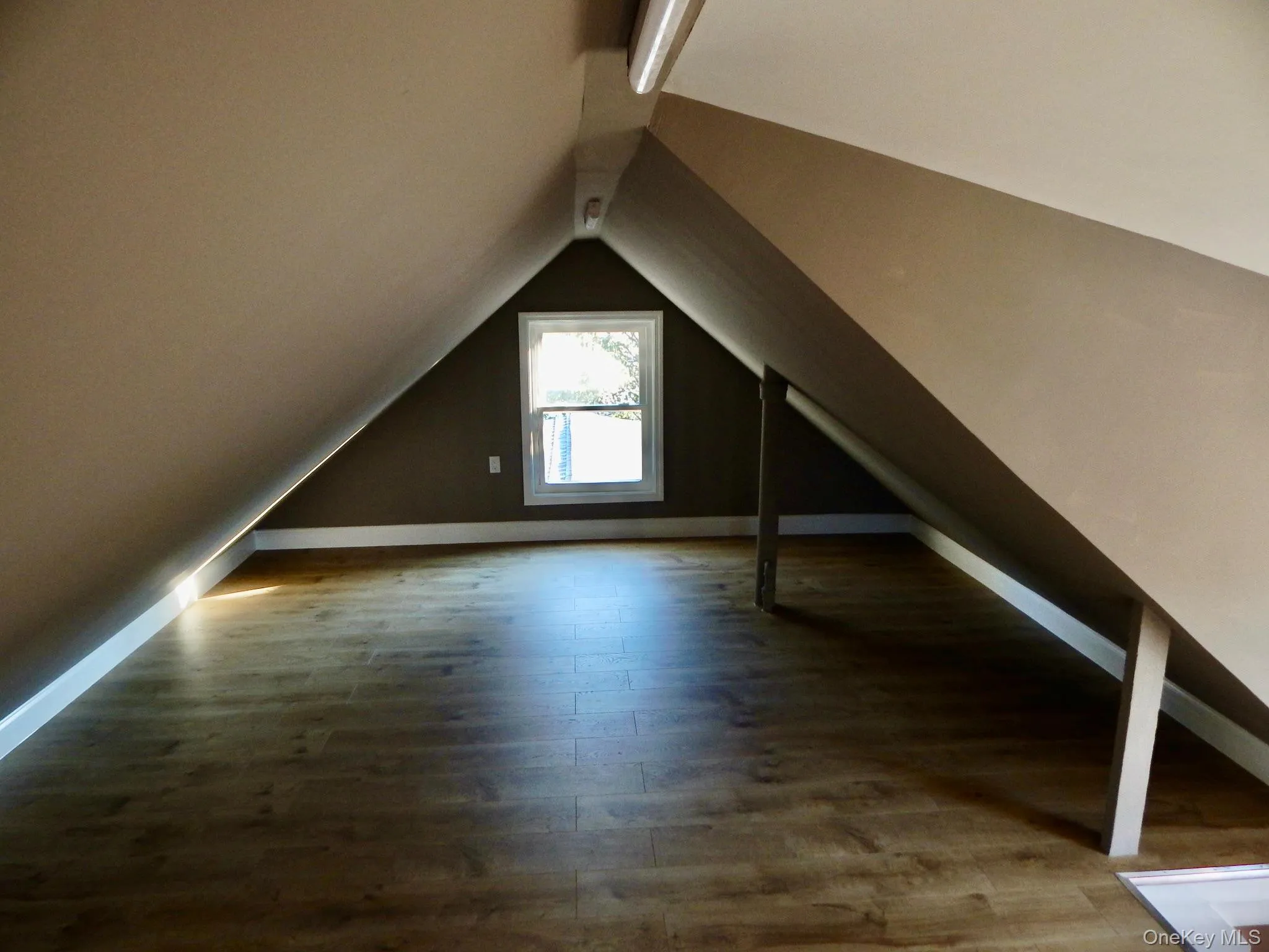 Additional living space featuring wood finished floors and lofted ceiling Additional living space featuring wood finished floors and lofted ceiling