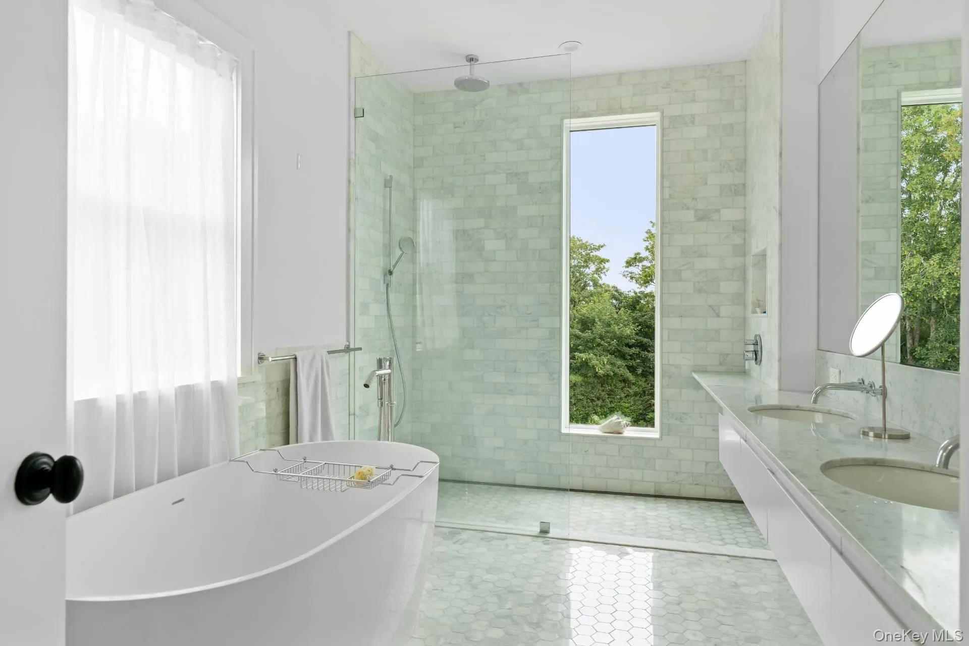 Bathroom with a walk in shower, a soaking tub, double vanity, tile walls, and tile patterned floors Bathroom with a walk in shower, a soaking tub, double vanity, tile walls, and tile patterned floors