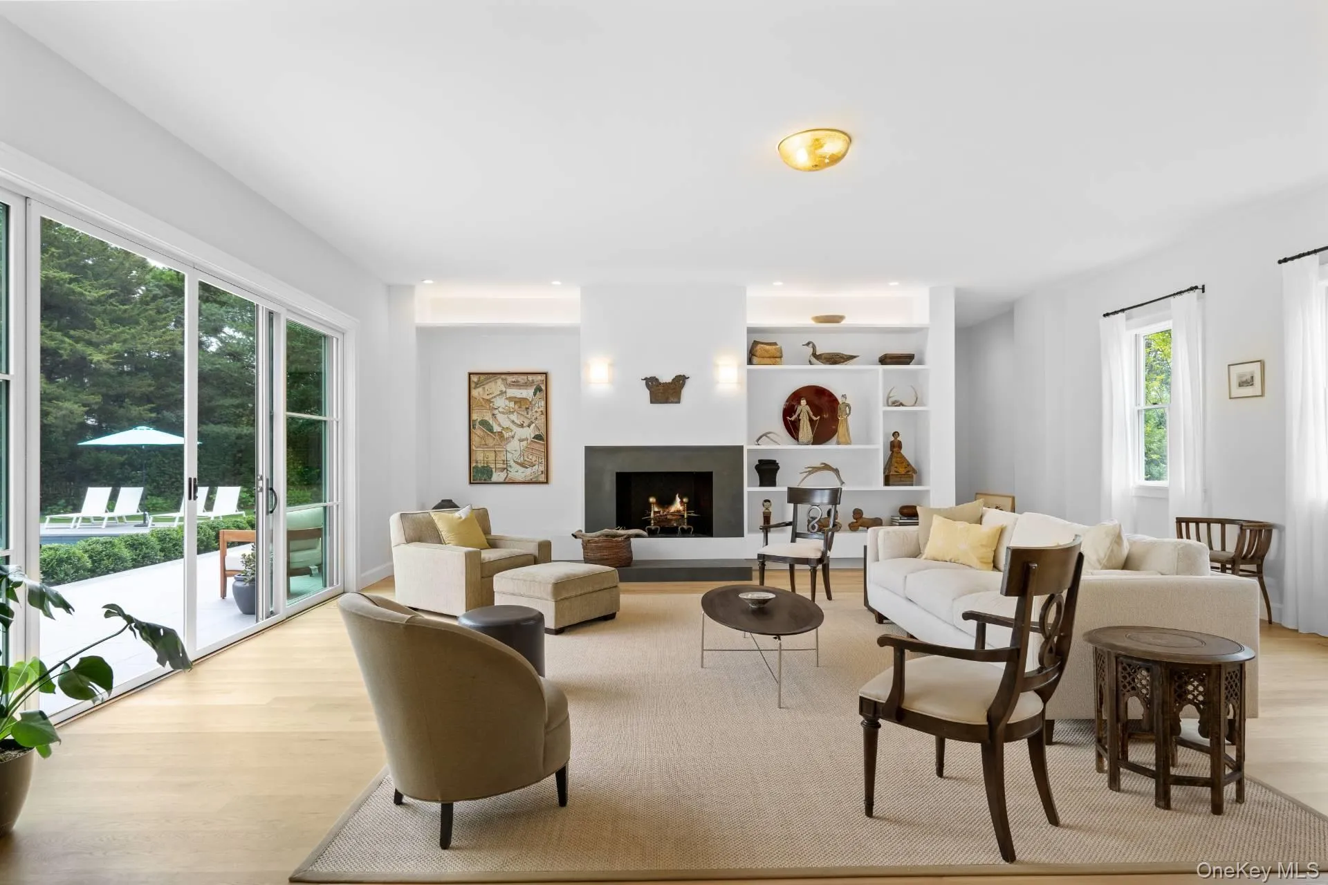 Living area with light wood-style floors and a lit fireplace Living area with light wood-style floors and a lit fireplace