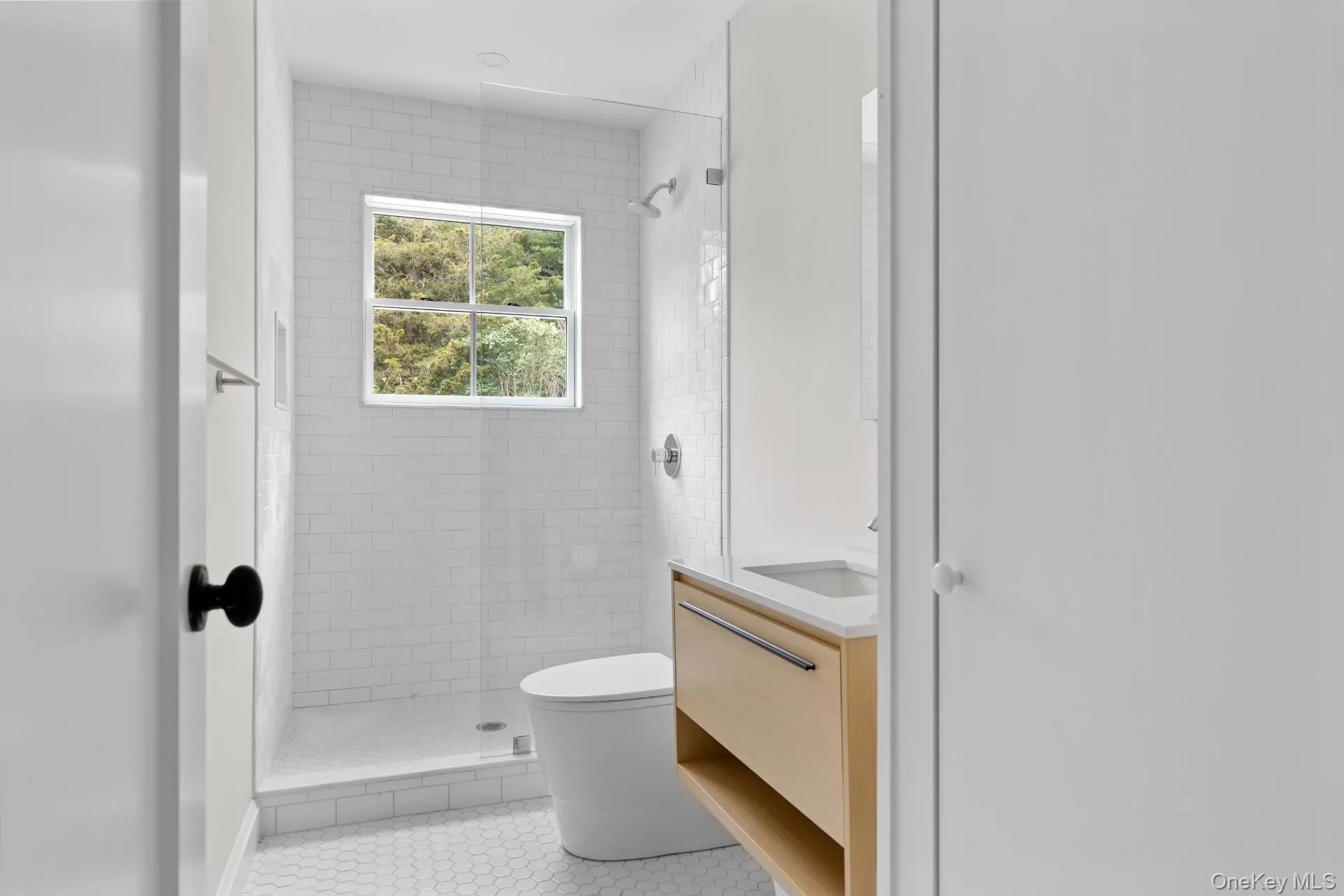 Bathroom featuring vanity, a stall shower, and light tile patterned floors Bathroom featuring vanity, a stall shower, and light tile patterned floors