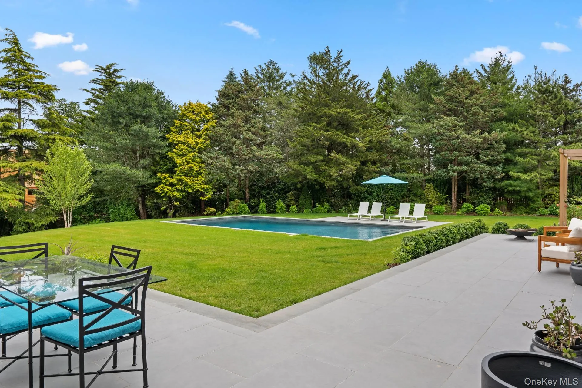 Outdoor pool featuring a patio, a yard, and outdoor dining area Outdoor pool featuring a patio, a yard, and outdoor dining area