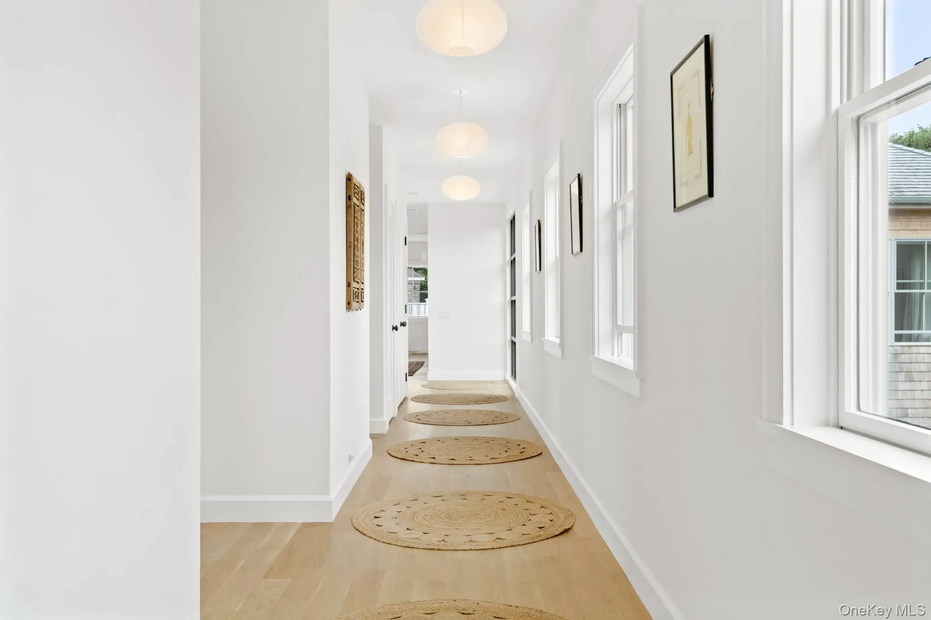 Corridor with light wood finished floors and plenty of natural light Corridor with light wood finished floors and plenty of natural light