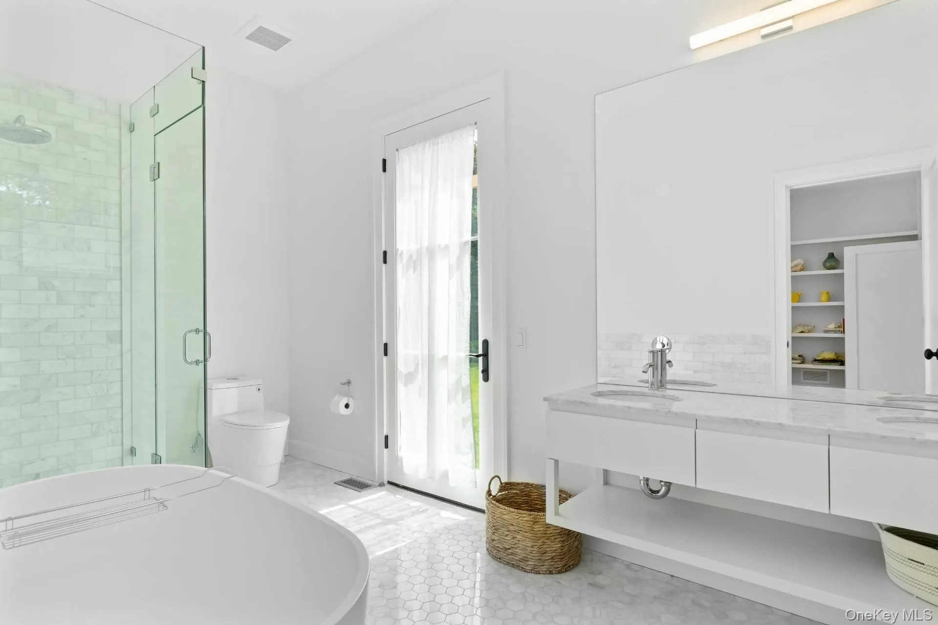 Bathroom featuring a shower stall, a soaking tub, double vanity, and light tile patterned flooring Bathroom featuring a shower stall, a soaking tub, double vanity, and light tile patterned flooring