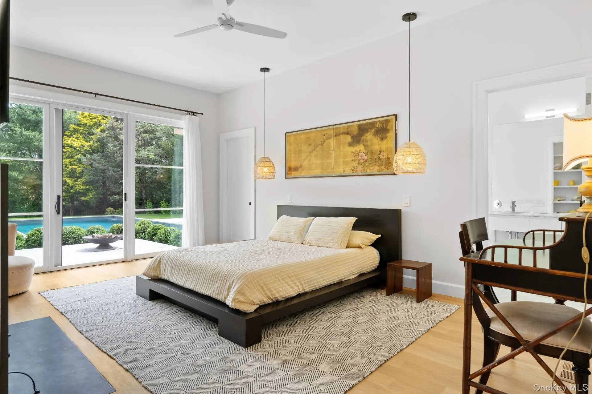 Bedroom with light wood finished floors, access to outside, and ceiling fan Bedroom with light wood finished floors, access to outside, and ceiling fan