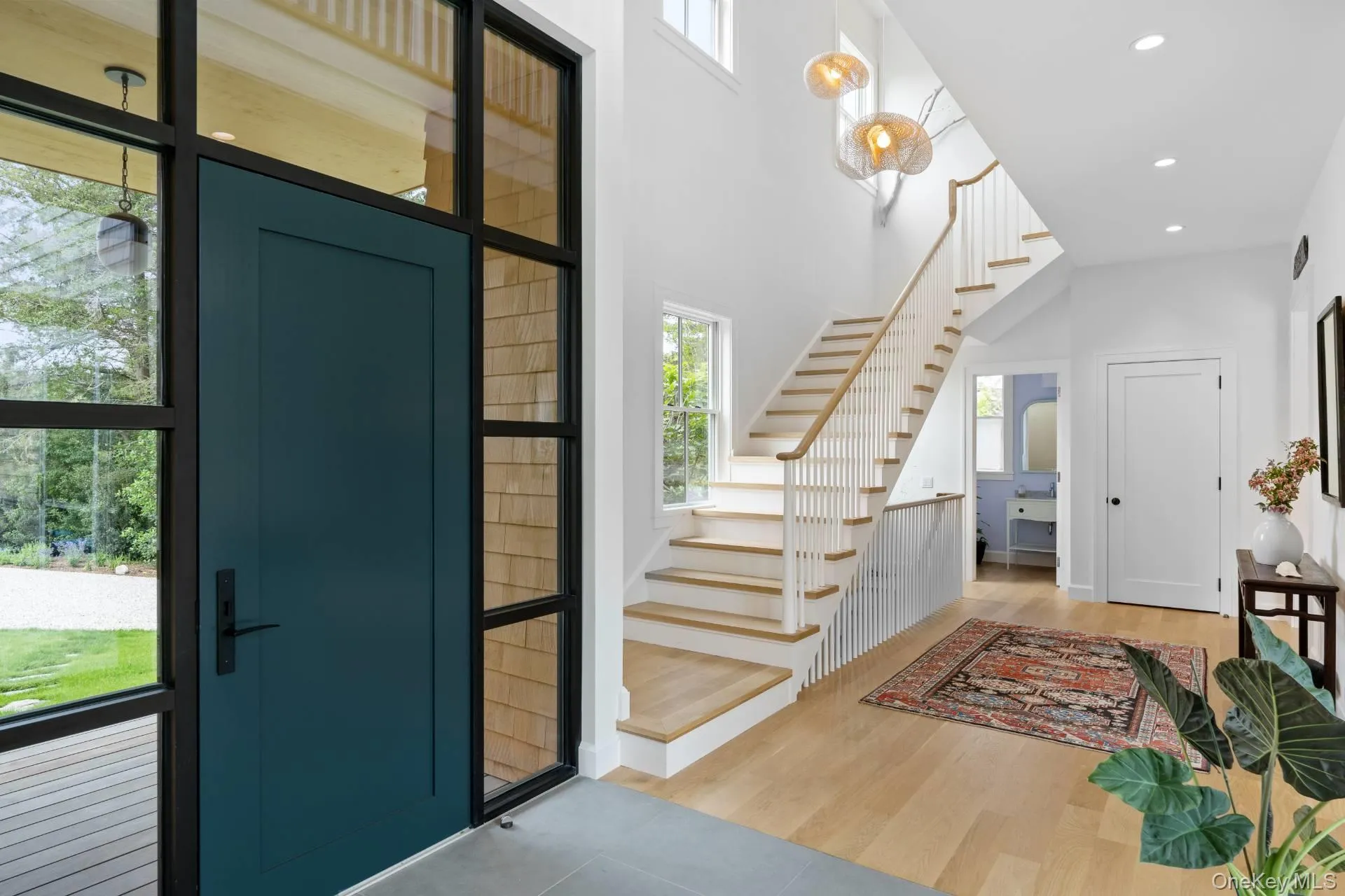 Foyer featuring light wood finished floors, stairway, recessed lighting, and a high ceiling Foyer featuring light wood finished floors, stairway, recessed lighting, and a high ceiling